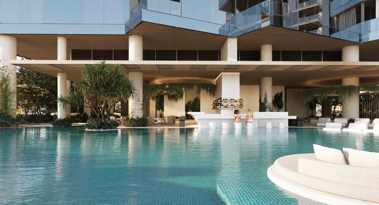Luxury outdoor swimming pool with a modern poolside bar and seating area in a high-end resort setting.