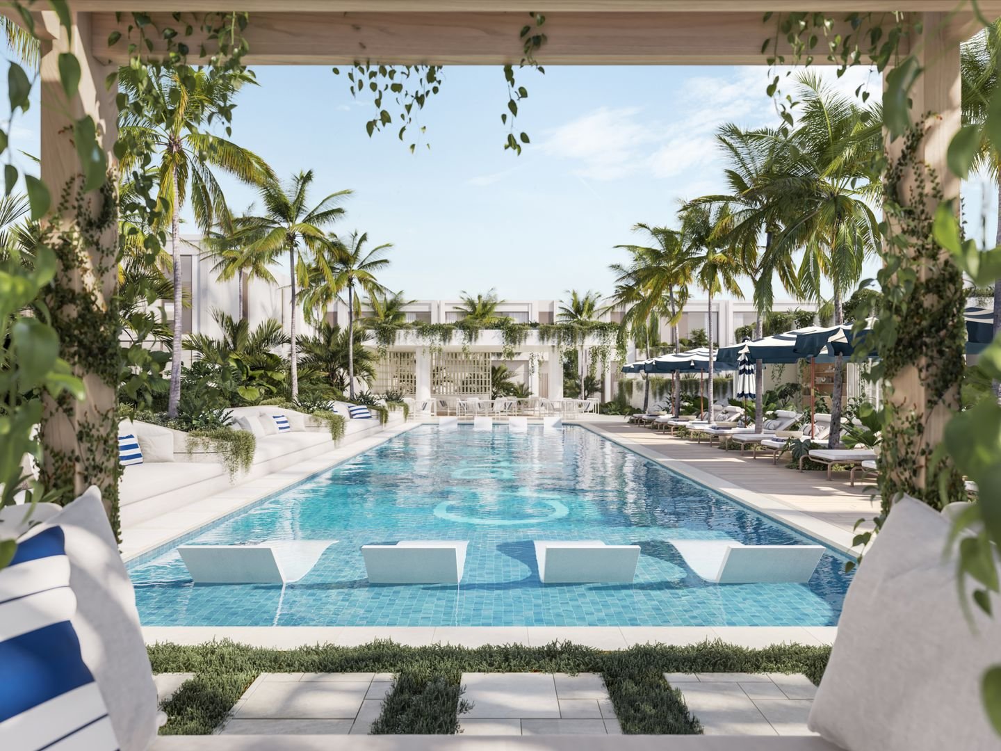Luxurious swimming pool surrounded by palm trees, lounge chairs, and umbrellas, with a pergola and greenery in the foreground.