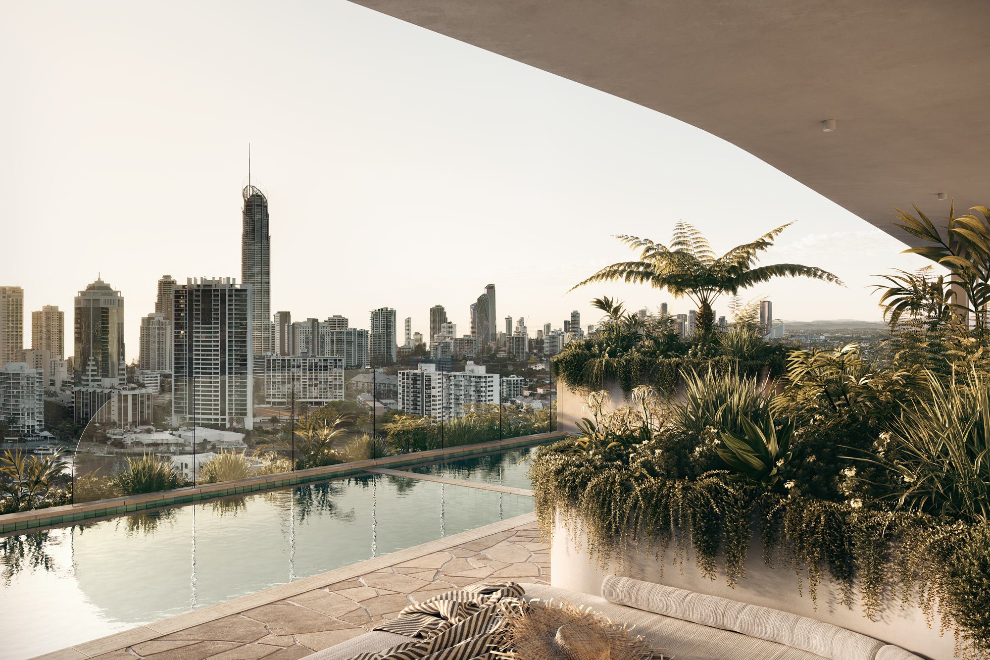 Rooftop infinity pool with city skyline view, surrounded by lush greenery and potted plants.