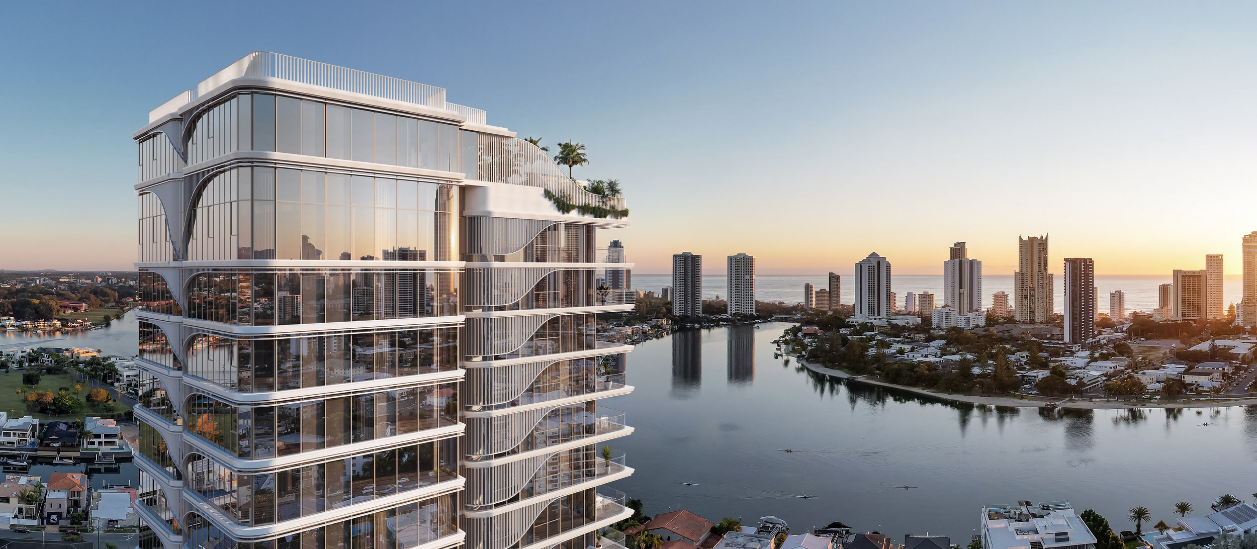 Modern high-rise building with glass facade, river and city skyline at sunset