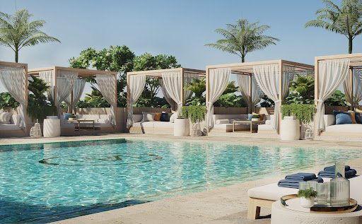 Luxurious outdoor pool area with cabanas, lounge chairs, and palm trees.