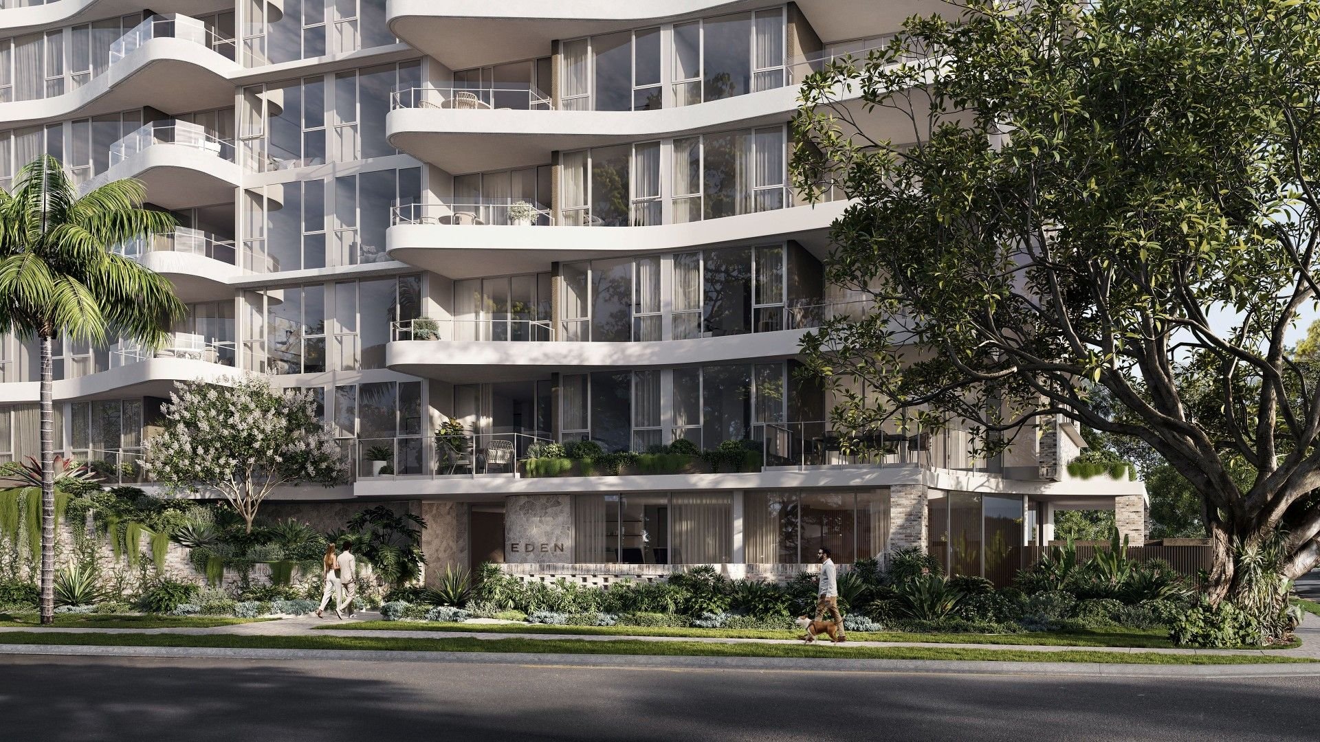 Modern apartment building with curved balconies, glass windows, and lush landscaping, featuring people walking and a large tree in the foreground.