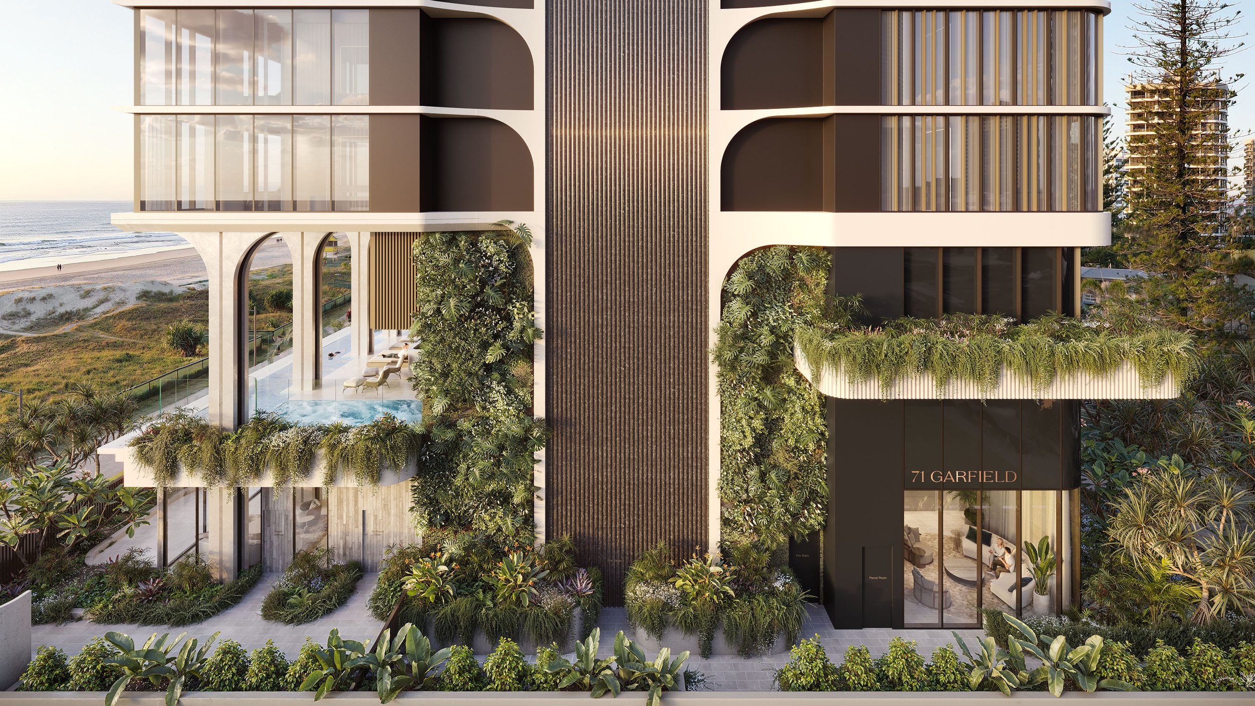Modern beachfront building with glass windows, lush greenery, and balconies overlooking the ocean.