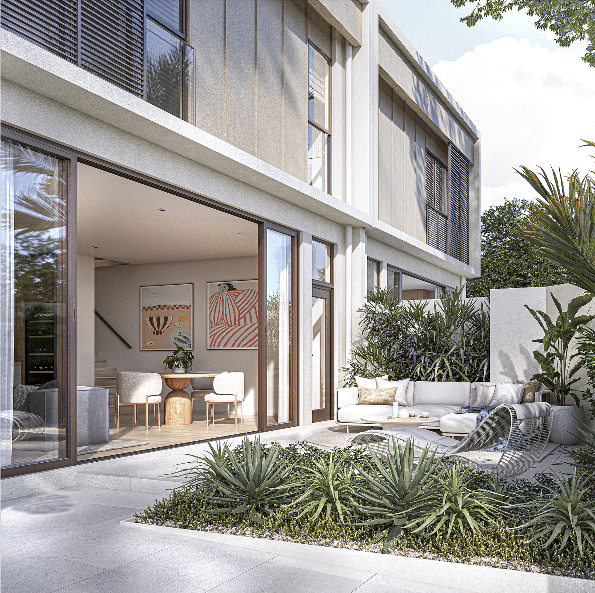 Modern outdoor patio adjoining a contemporary home with large glass doors, a seating area with white cushions, and lush greenery.