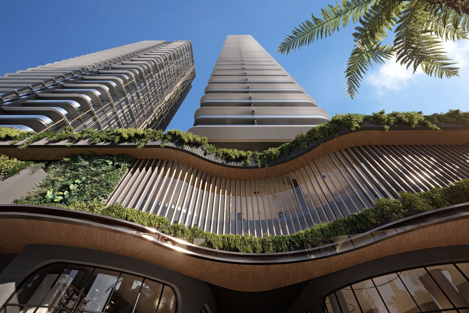 Modern skyscrapers with green architectural features and vertical gardens against a clear blue sky.