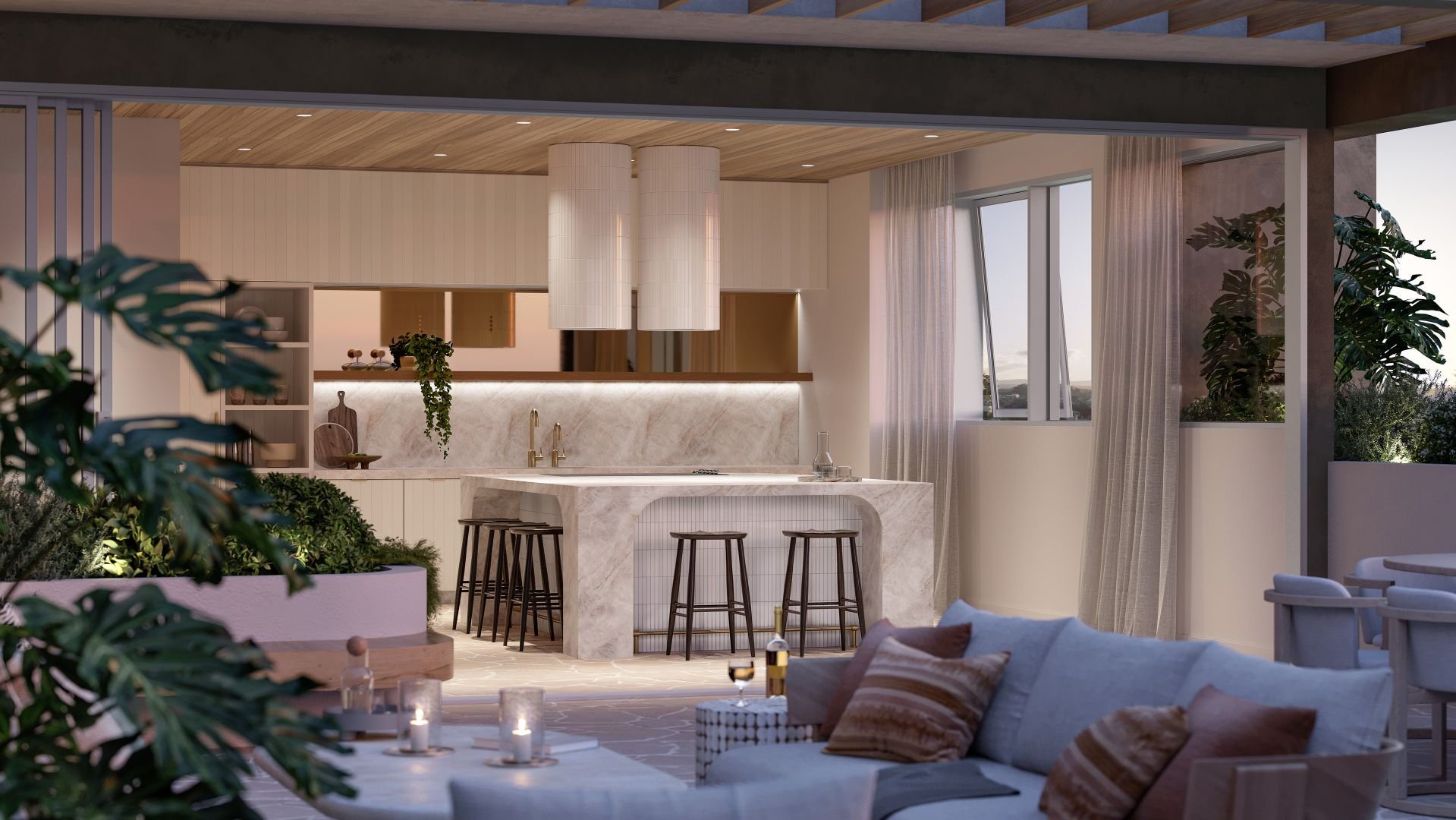 Modern kitchen and outdoor lounge area with marble countertops, hanging lights, bar stools, plush seating, plants, and candles.