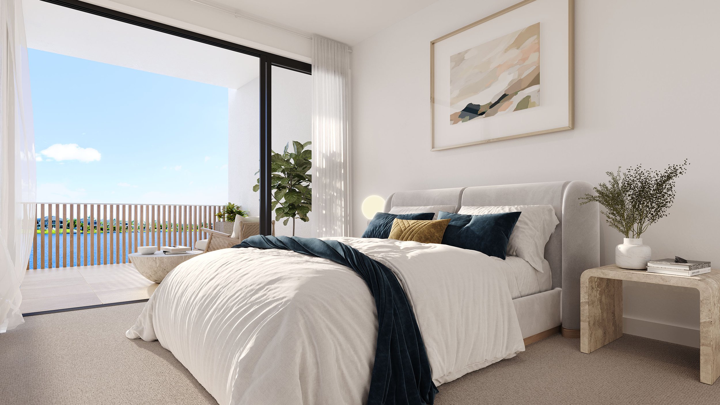 Modern bedroom with a large bed, white bedding, blue throw, decorative pillows, and a wooden bedside table. A large window opens to a balcony with outdoor seating overlooking a scenic view. Artwork is hung above the bed, and a potted plant is in the