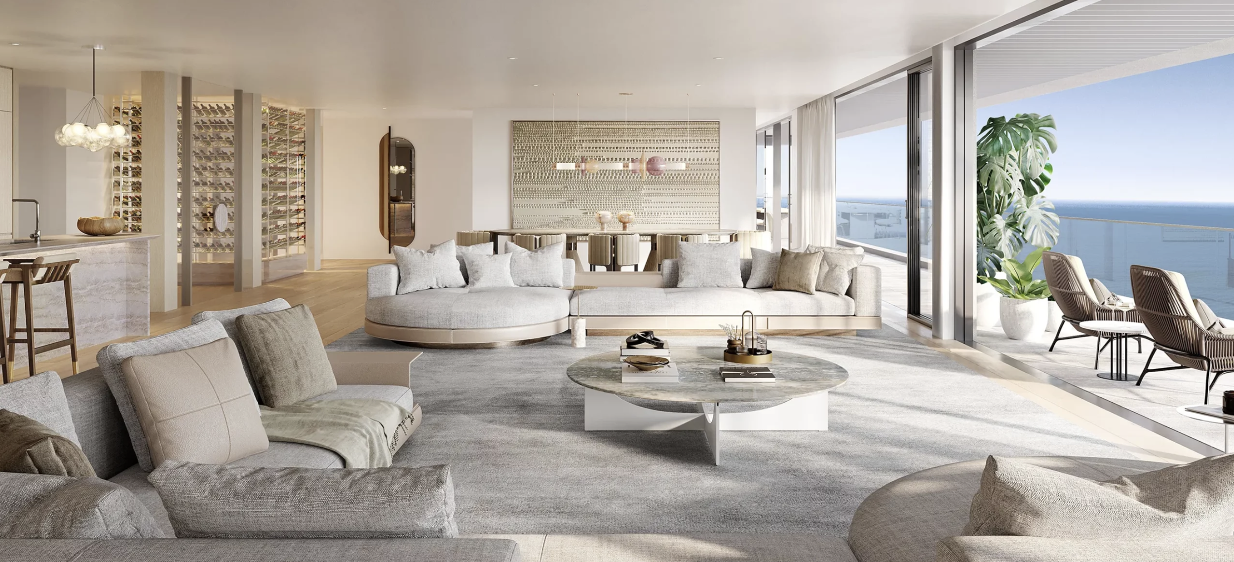 Modern living room with large windows, ocean view, and contemporary furniture including a round coffee table, sectional sofa, and built-in wine display.