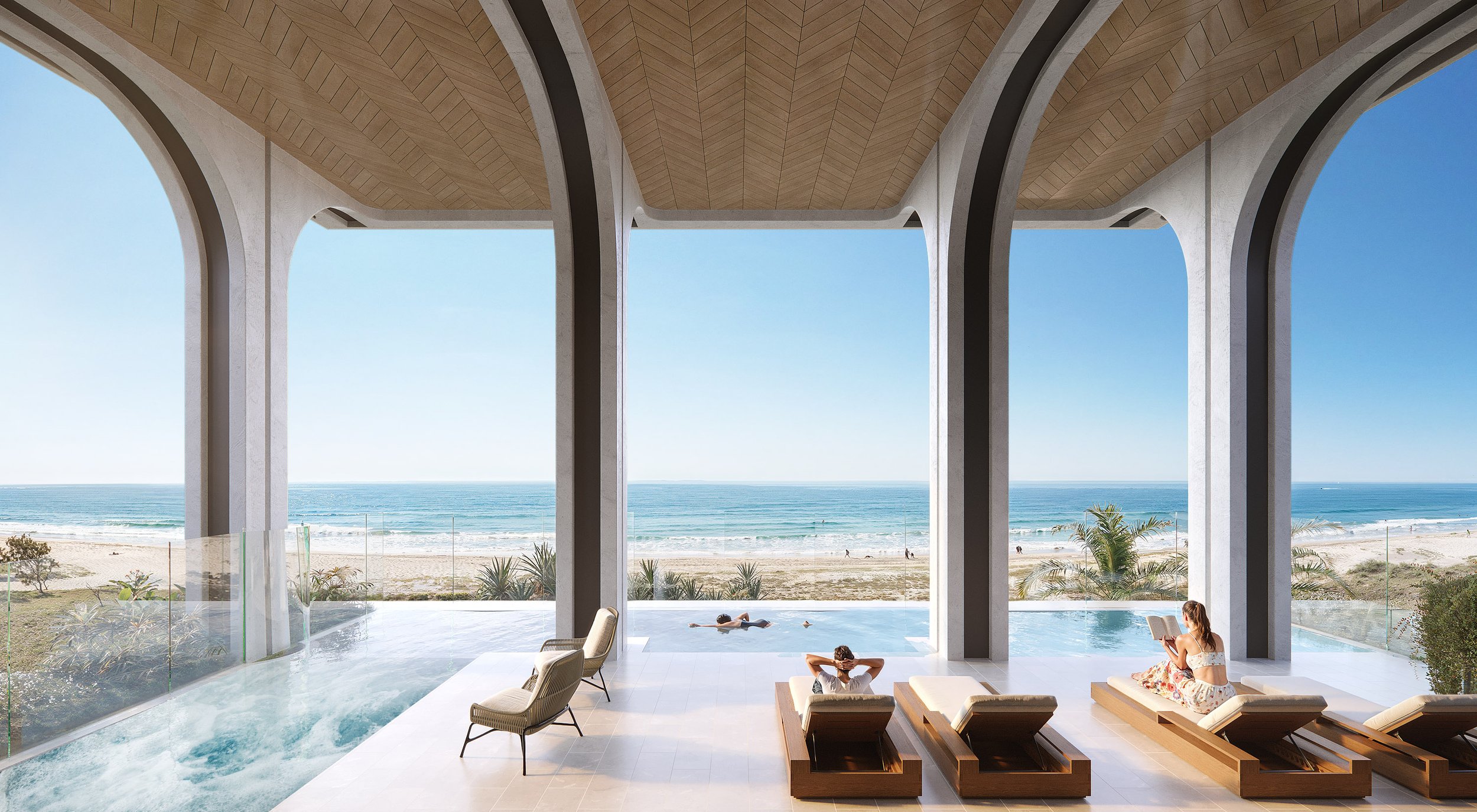Luxury beachfront view with arches, infinity pool, lounge chairs, and ocean scenery.