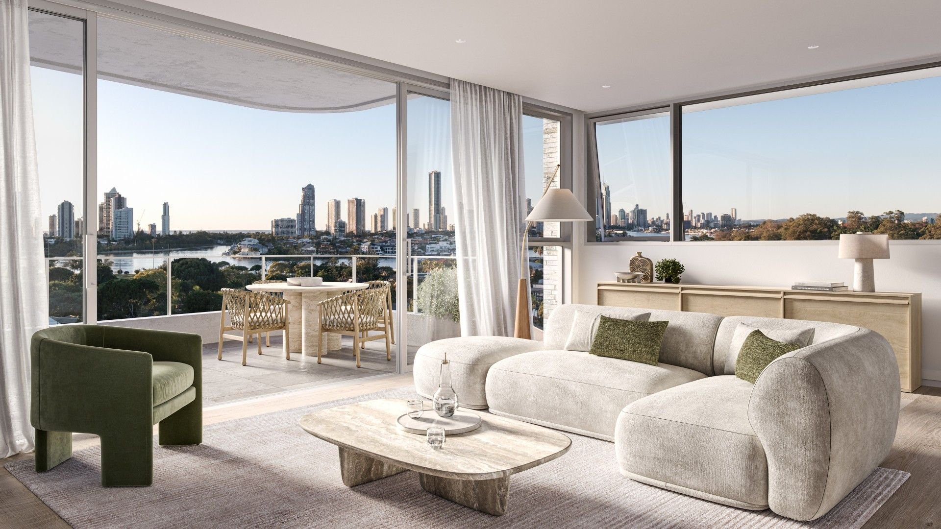 Modern living room with beige sofa, green armchair, and a wooden coffee table. Large windows offer a cityscape view, and a balcony with a dining set is visible outside.