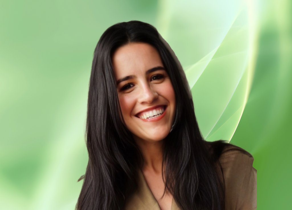 A young woman with long dark hair smiling against a green abstract background.