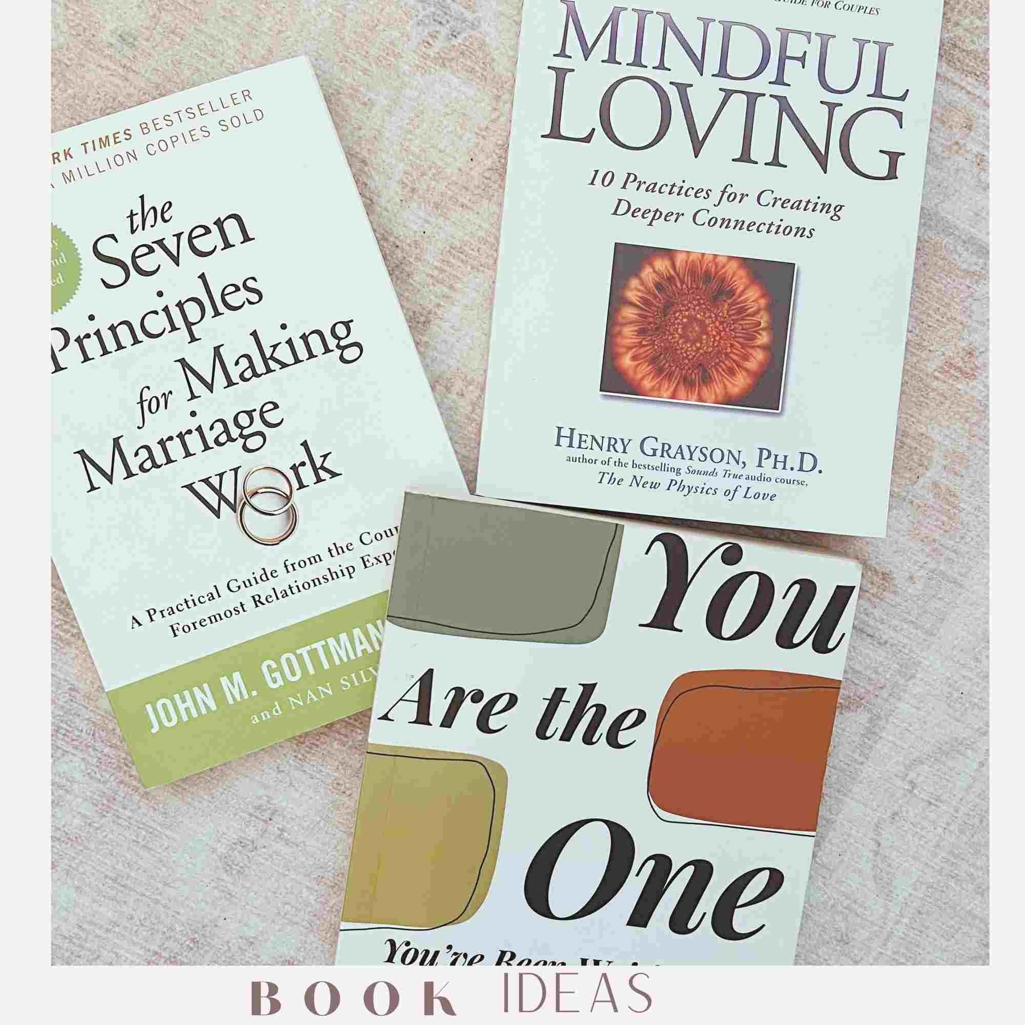 Three books related to relationships and mindfulness lie on a light-colored surface. The titles are 'The Seven Principles for Making Marriage Work,' 'Mindful Loving,' and 'You Are the One.'