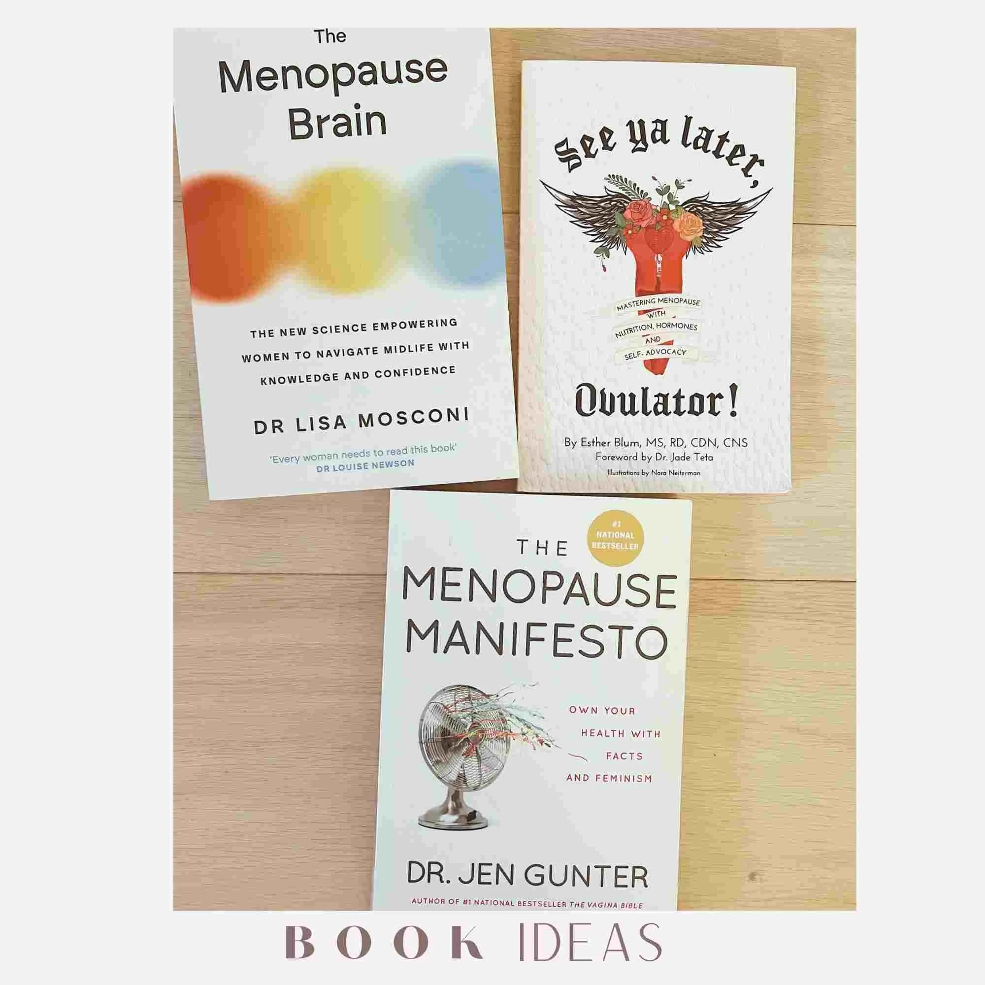 Three books related to menopause and hormones are spread out on a light wooden surface. The titles include "The Menopause Brain," "See Ya Later, Ovulator!" and "The Menopause Manifesto."