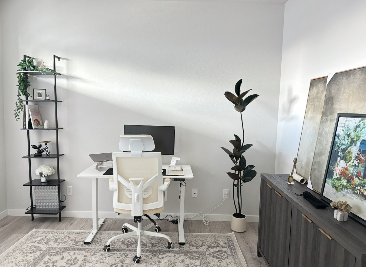A laptop and smartphone displaying a website titled 'The Bloom Collective' with articles about Reiki and wellness, featuring a neon sign image saying 'and breathe' in a greenery background.