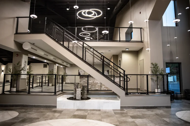 Tower Event and Conference Center interior staircase with stone water feature in the lobby