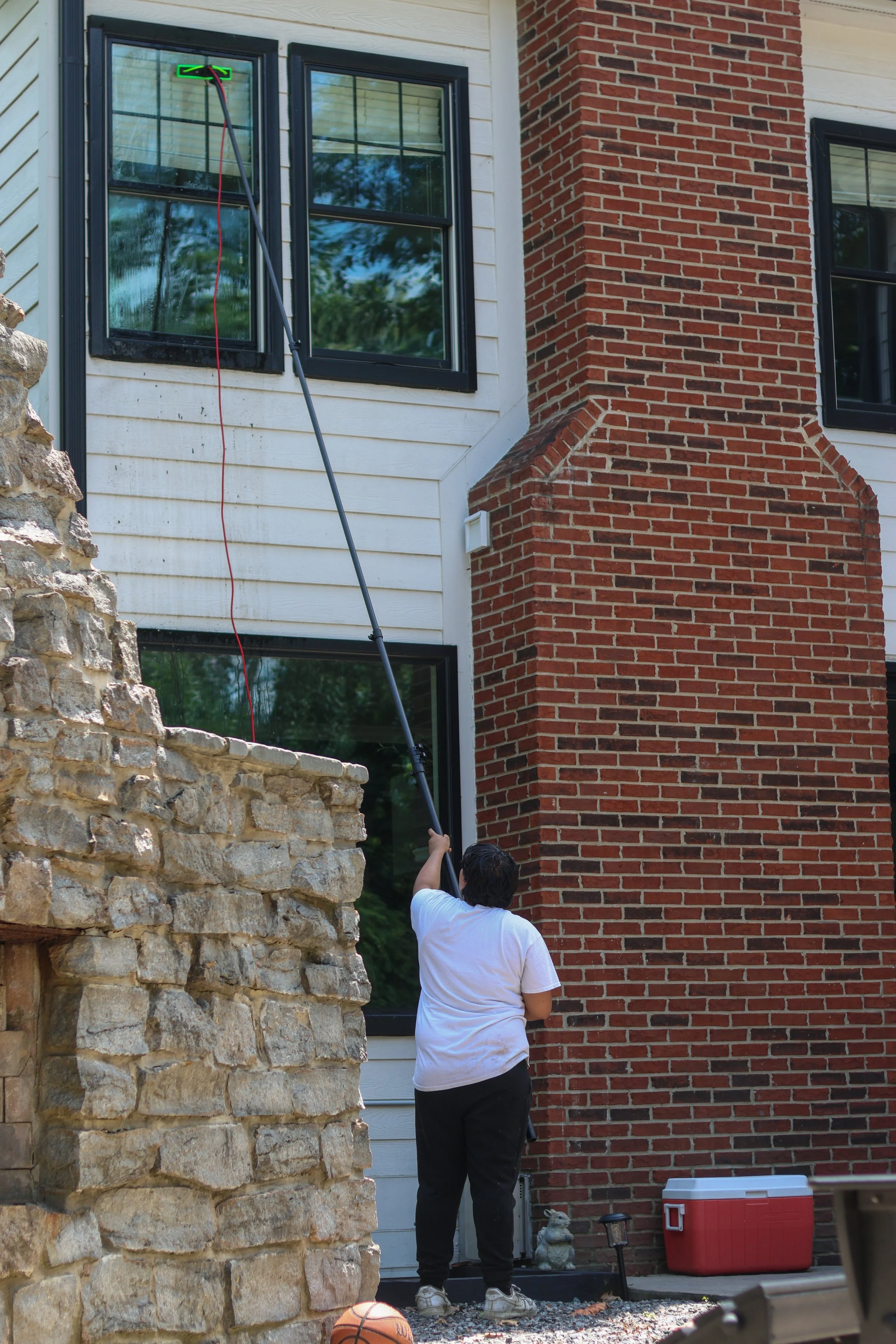 Residential second-story window cleaning using water-fed pole in Carmel Indiana
