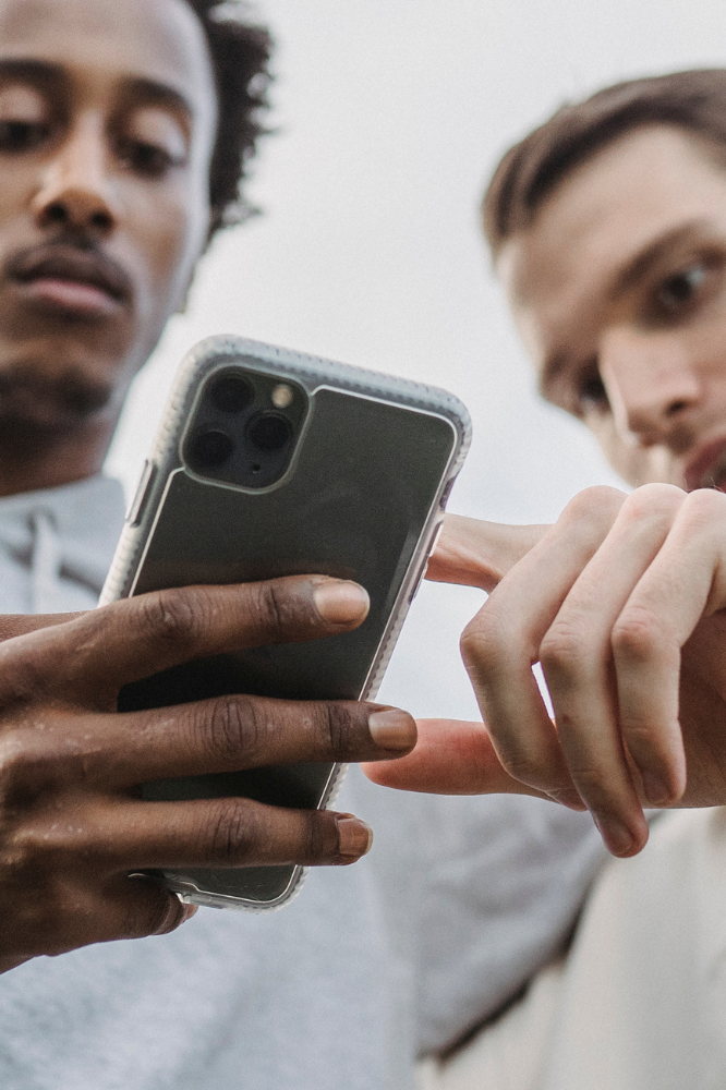 Two males browsing iphone