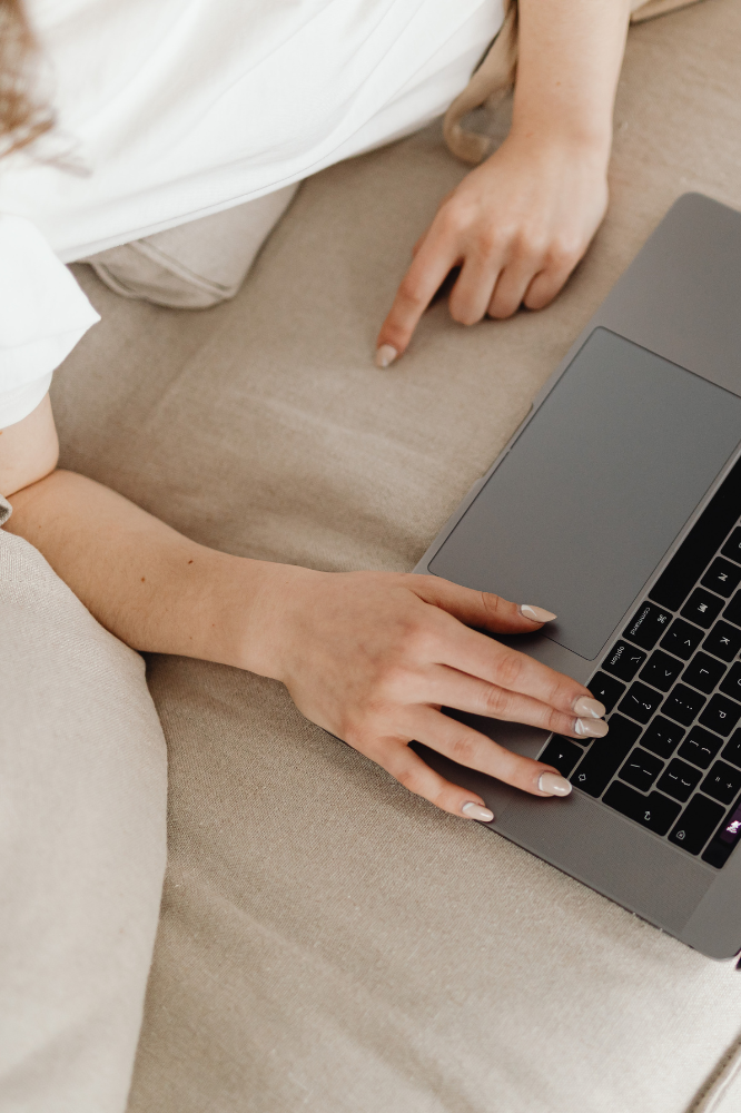 woman browsing laptop on couch