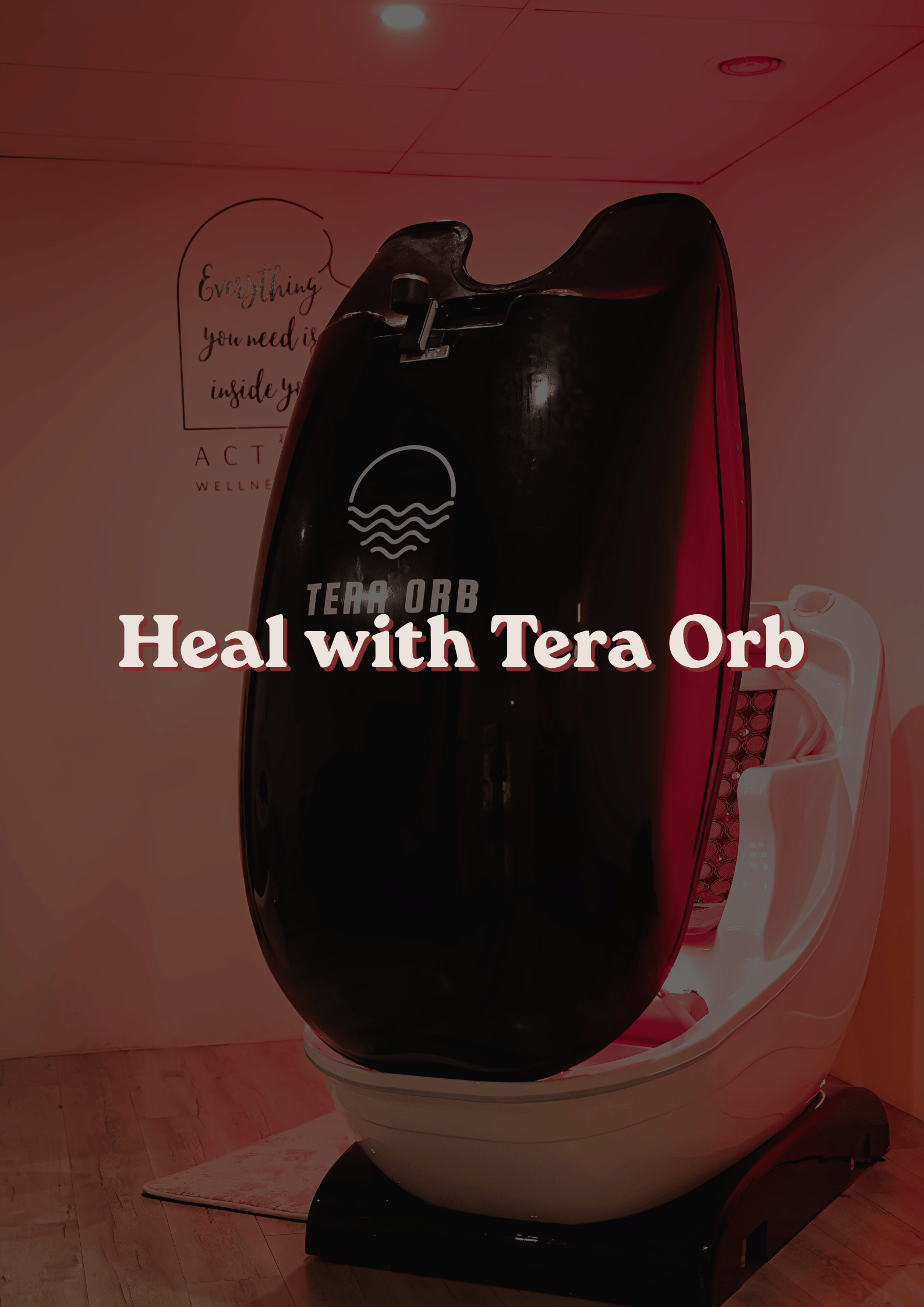A modern red and black sensory deprivation tank in a wellness center, with a sign on the wall that reads 'Everything you need is inside you.'