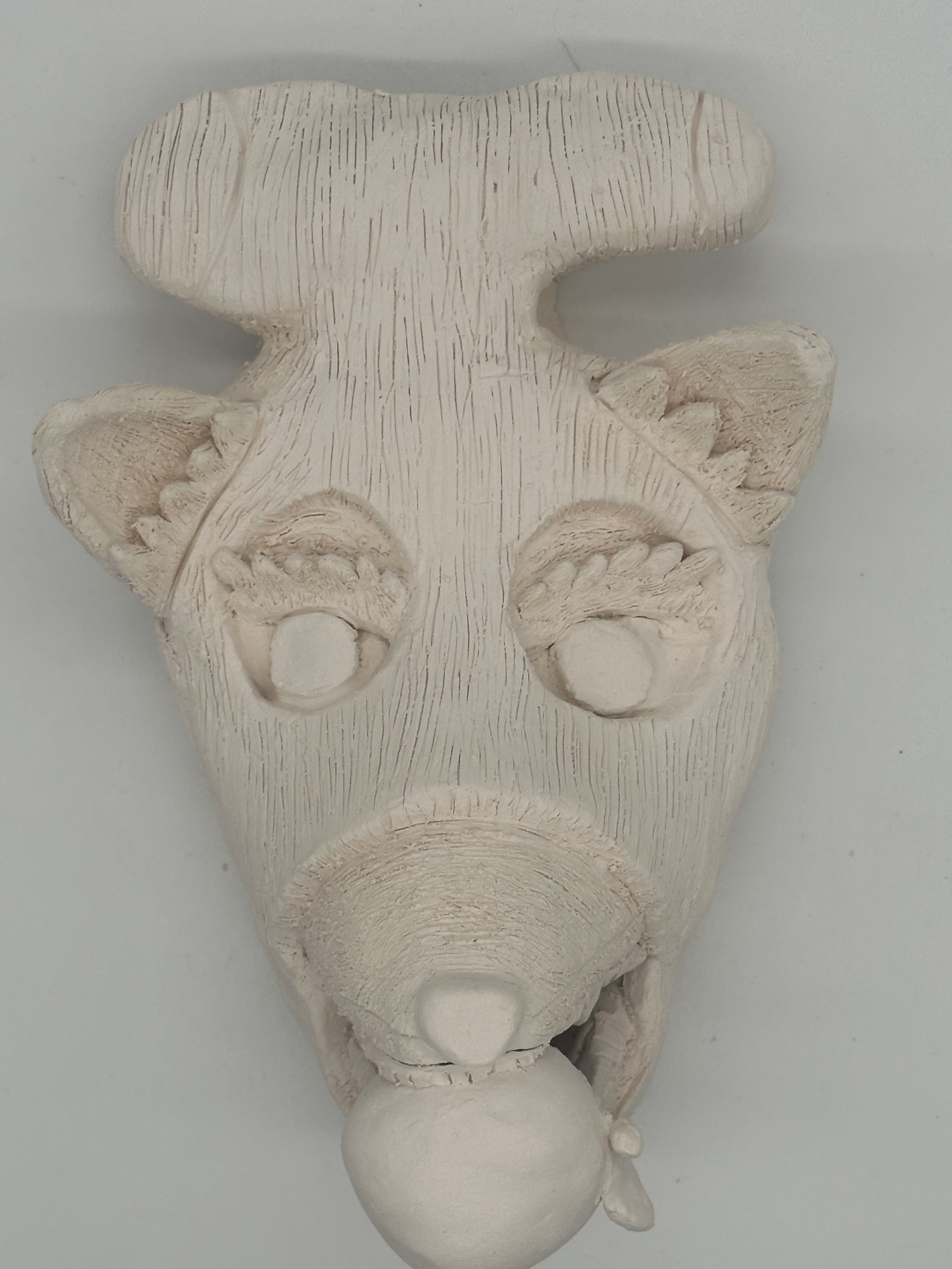Bisqued student mask with detailed construction.