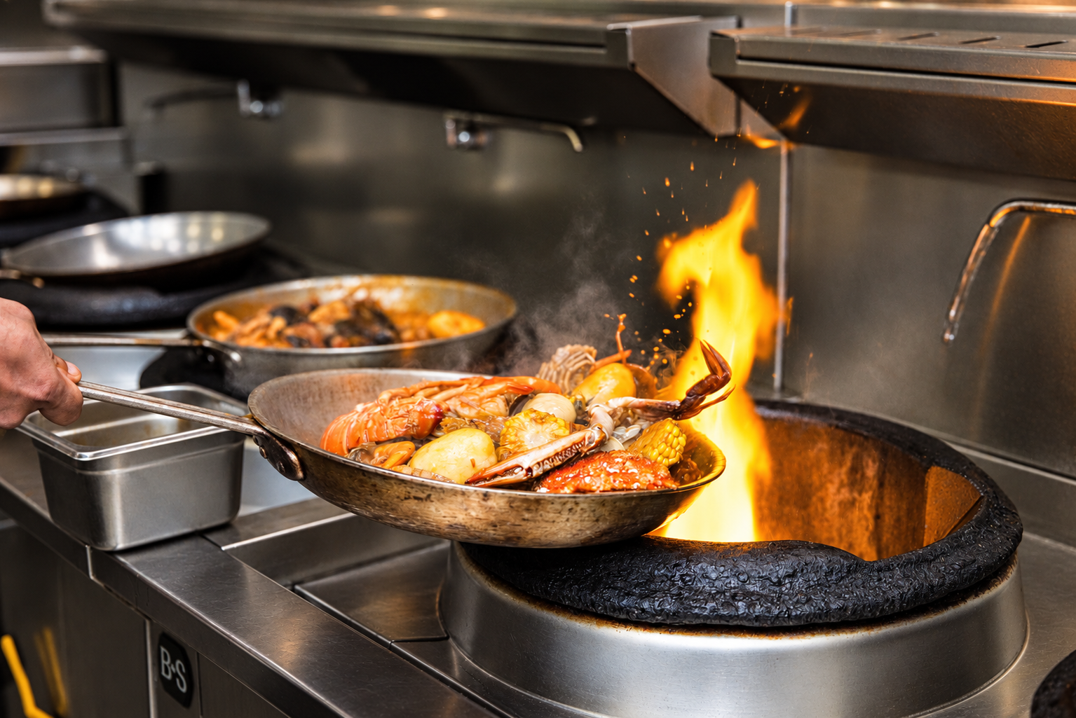 Seafood boil being cooked over an open flame in the Lusso Tapas kitchen