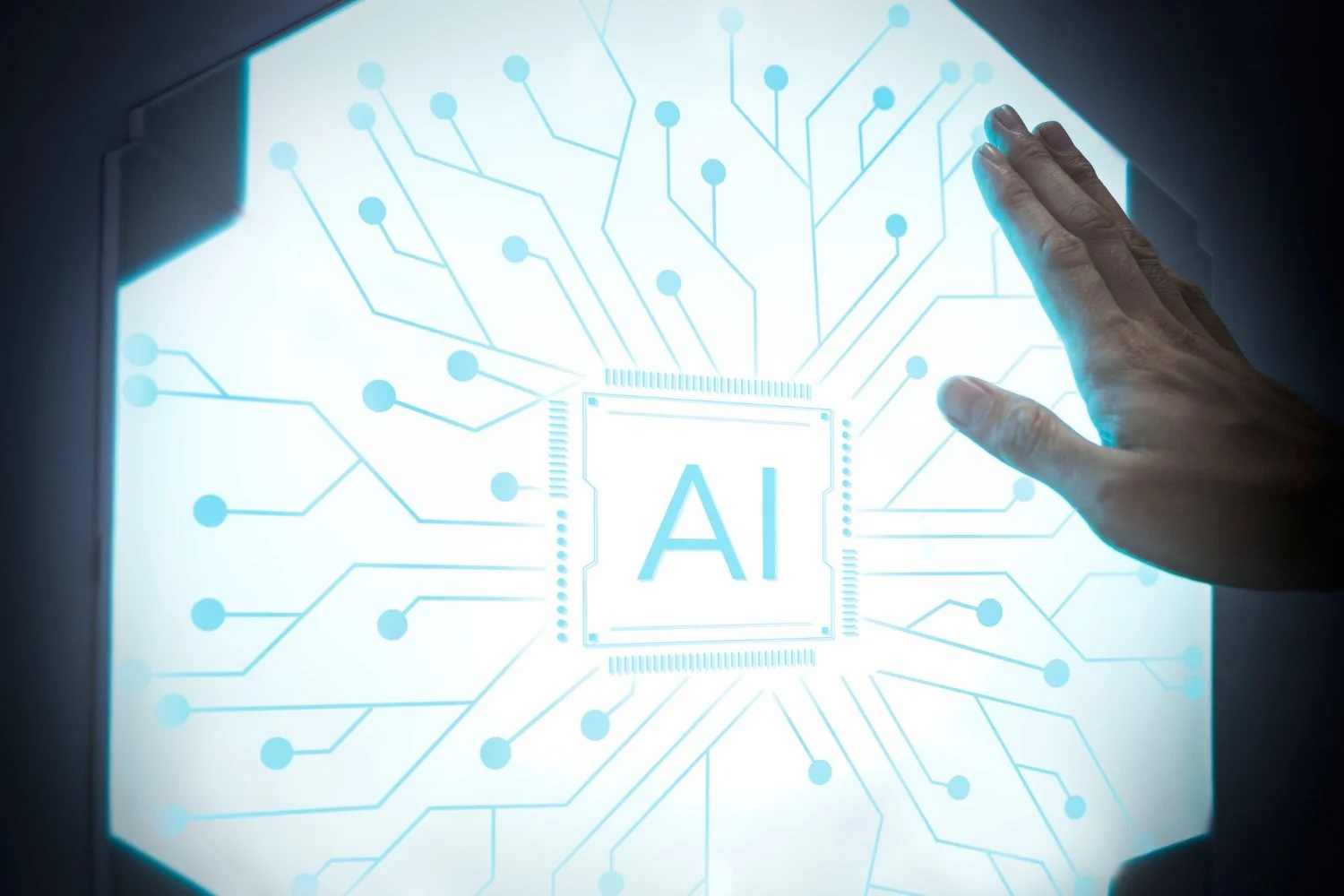 A hand reaching towards a digital screen displaying a circuit-like design with the letters 'AI' in the center, representing artificial intelligence technology.