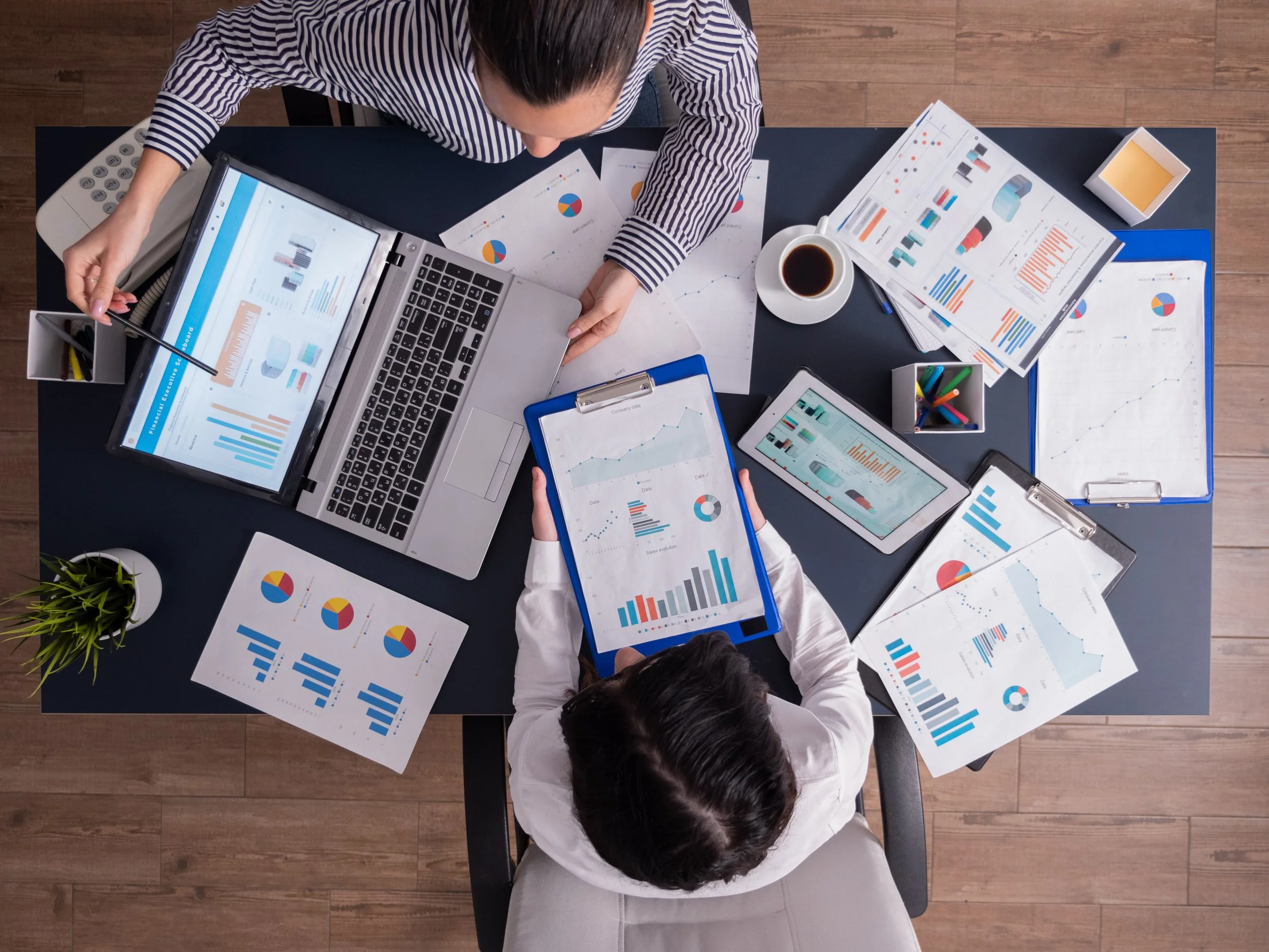 Business team analysing digital marketing strategy using analytics reports and performance data in a professional meeting environment
