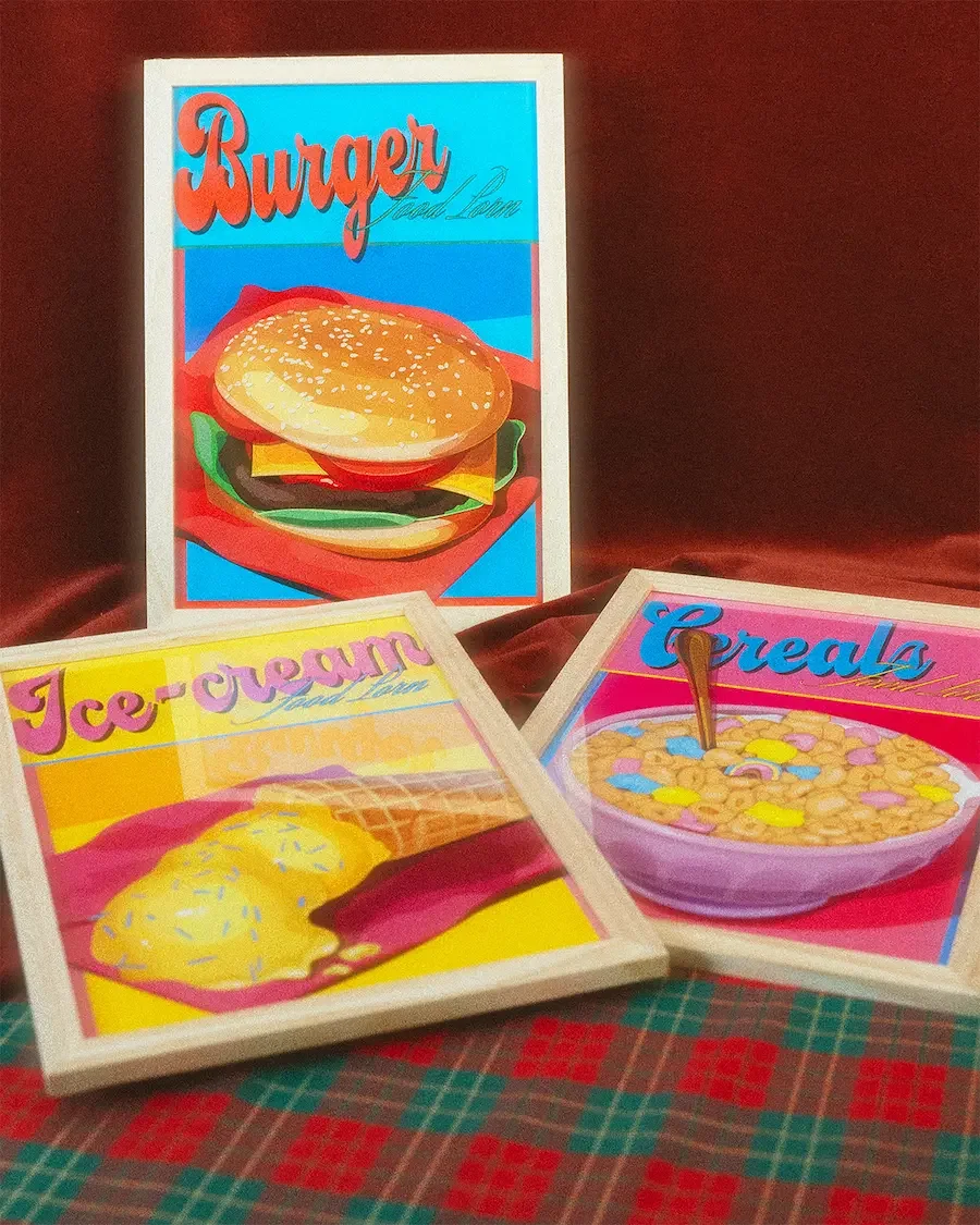 Affiches encadrées de la collaboration Voilà Coco x Marie Devine “Food Porn” : illustrations rétro colorées des plats Burger, Ice Cream et Cereals, typographies arrondies vintage et univers pop inspiré des années 70.