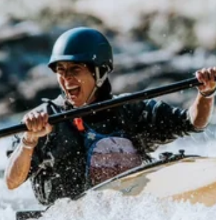 woman in a kayak on the river laughing