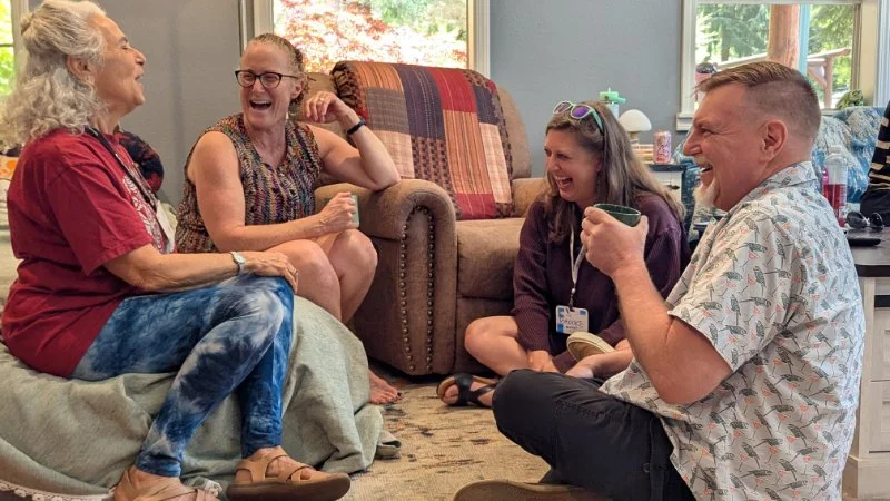 4 people laughing in a workshop
