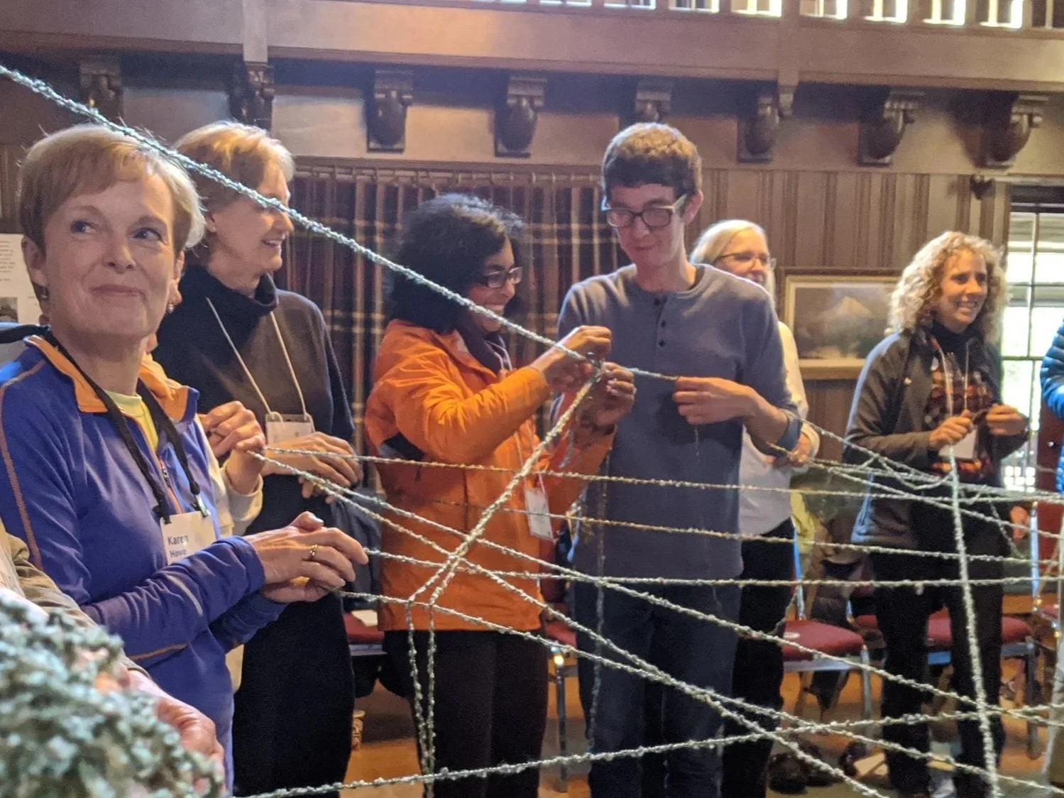 people working with string, smiling
