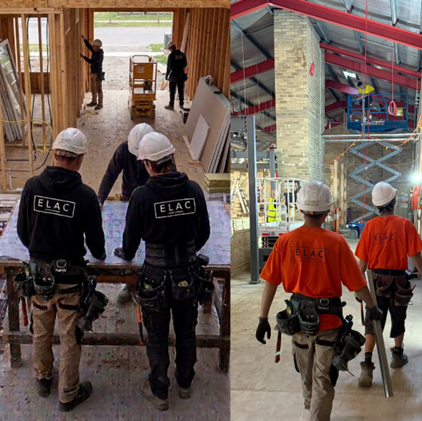 Construction workers wearing ELAC shirts and hard hats on a building site, inspecting plans and working inside a partly built structure with brick walls and scaffolding.