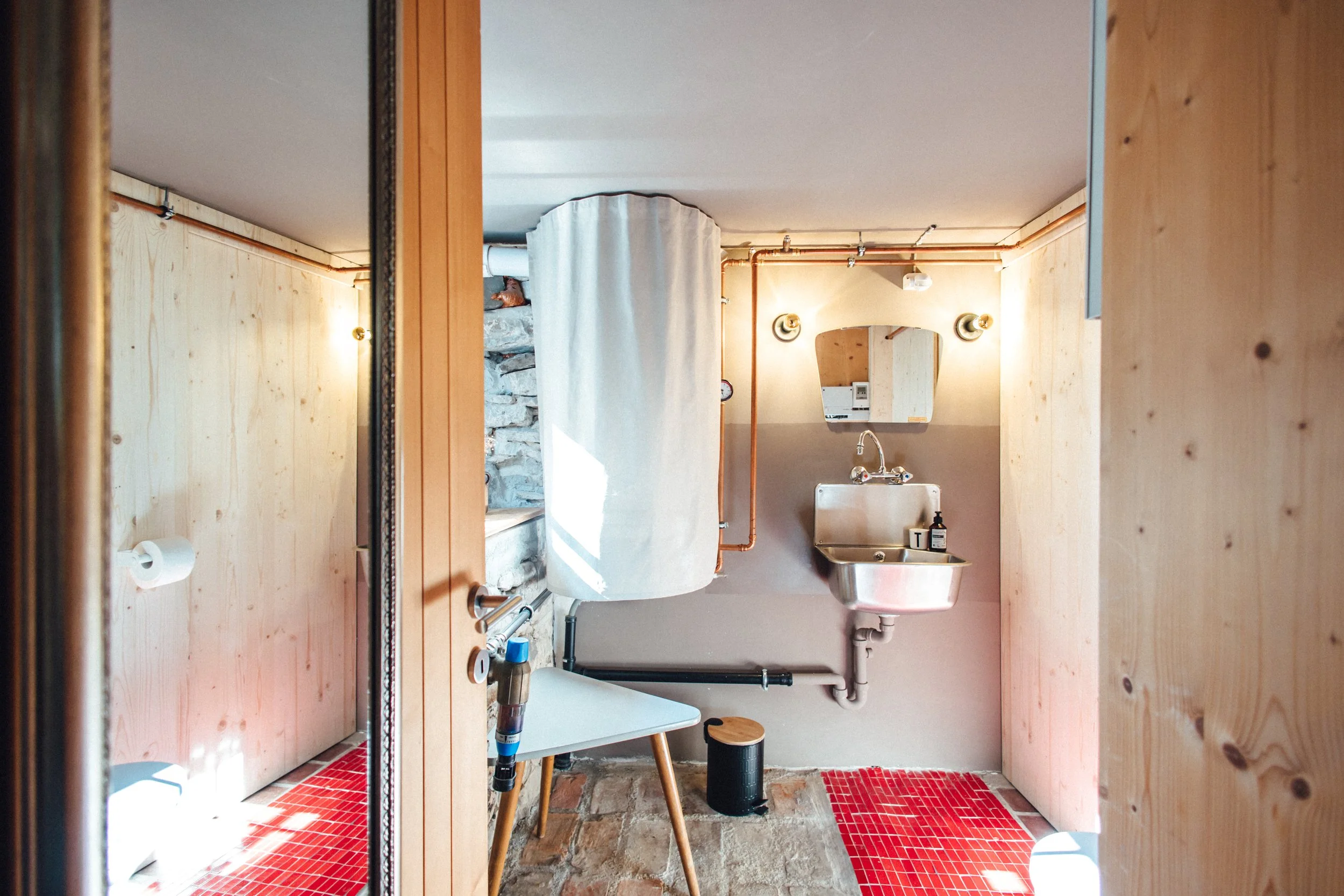 rustikales Bad im industrial design look, Kupferrohre, Retro Waschbecken, Vintage Spiegel, rote Bodenfliesen