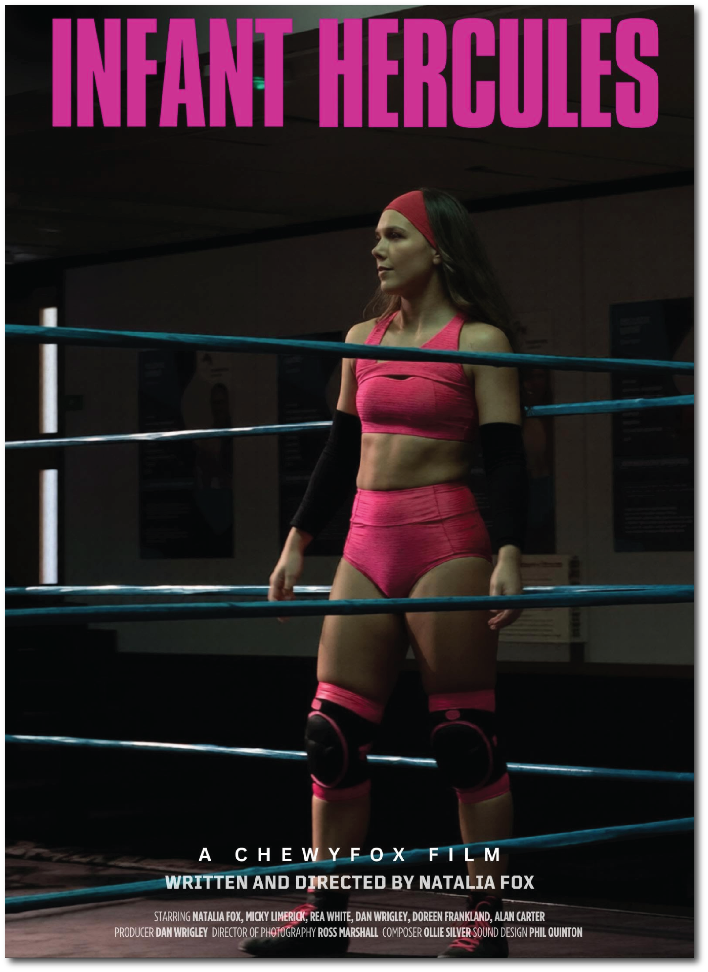Poster for the movie 'Infant Hercules' showing a woman in a pink sports bra, matching shorts, and pink knee-high socks with black knee pads, standing inside a boxing ring with a serious expression. The title 'Infant Hercules' is in large purple text at the top, and there is additional text indicating it is a ChewyFox film written and directed by Natalia Fox.