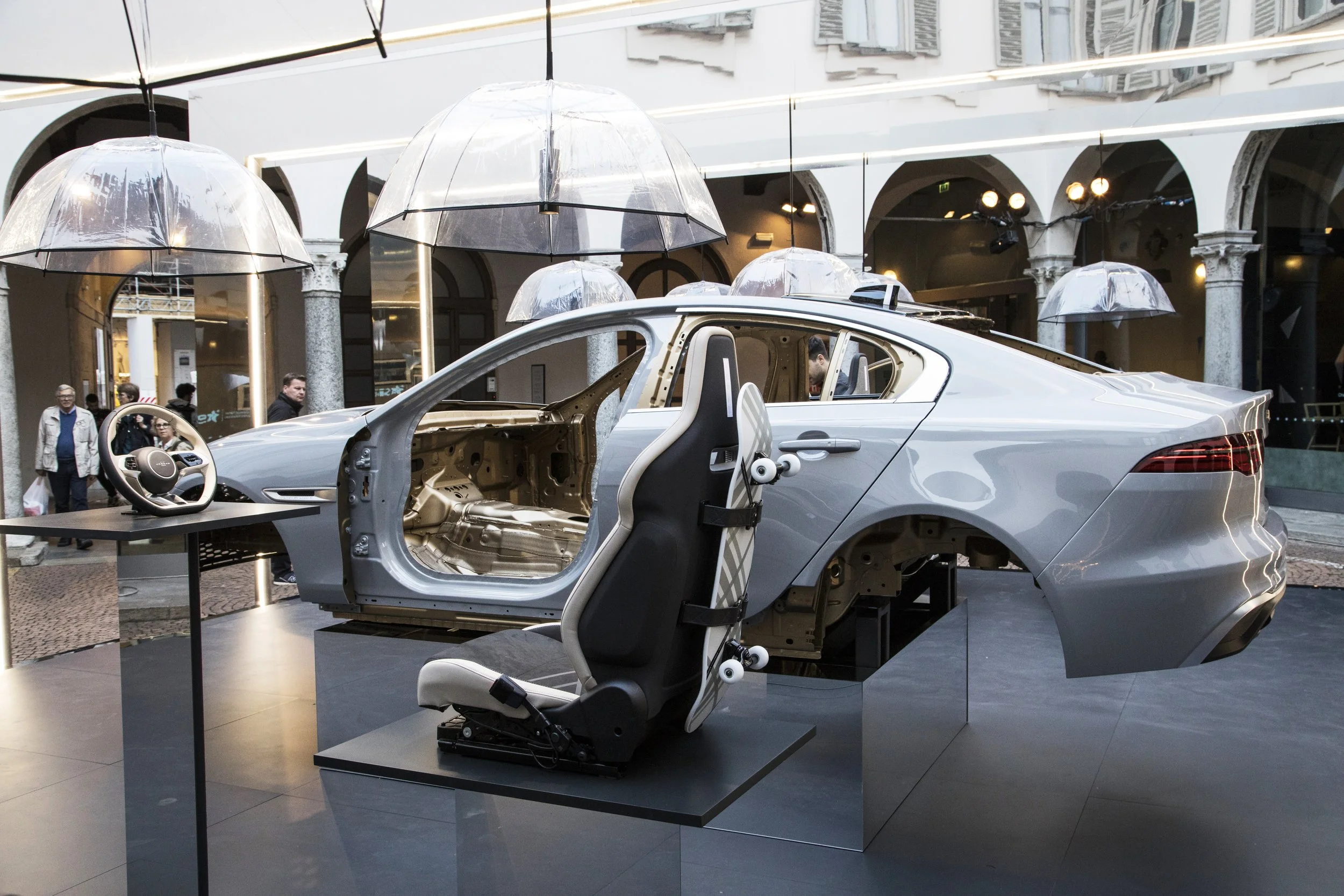 Art installation with car body and seat in courtyard