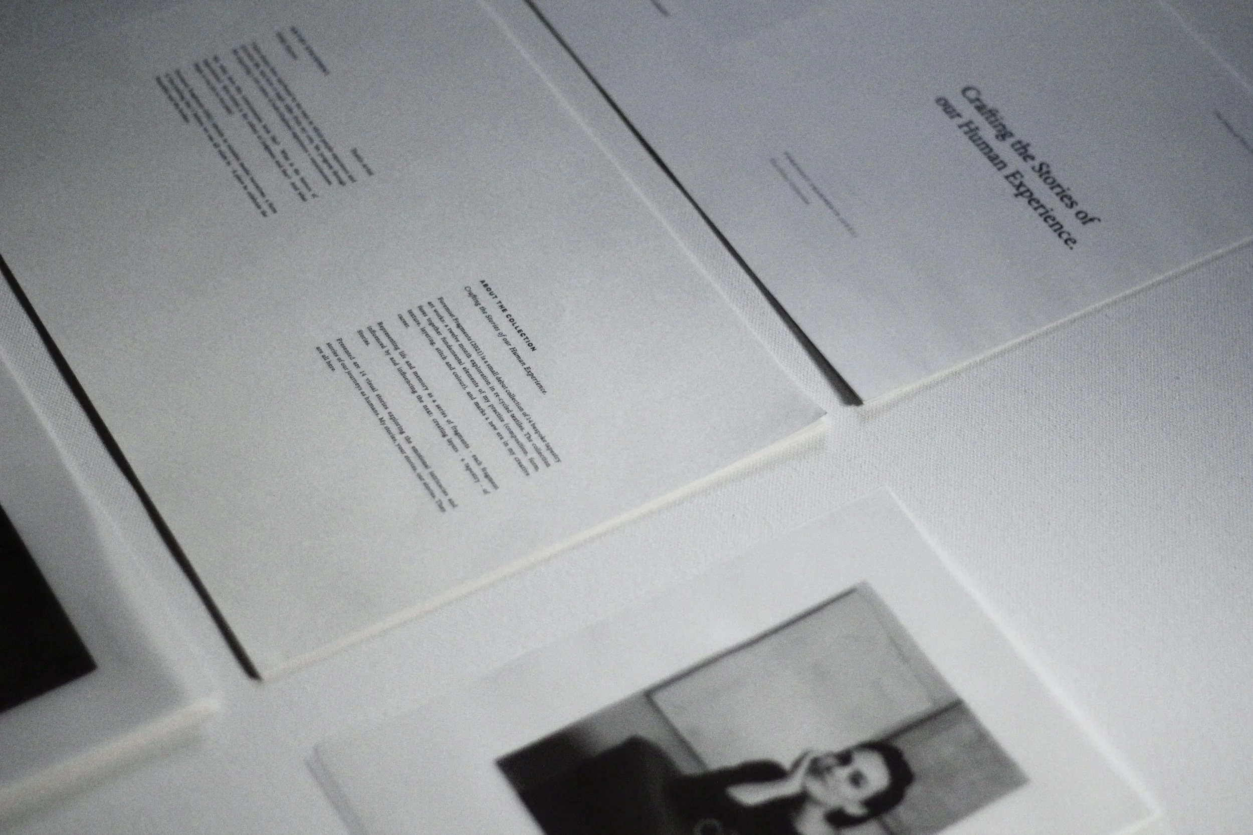 Assorted printed documents and a black and white photograph laid on a white surface.