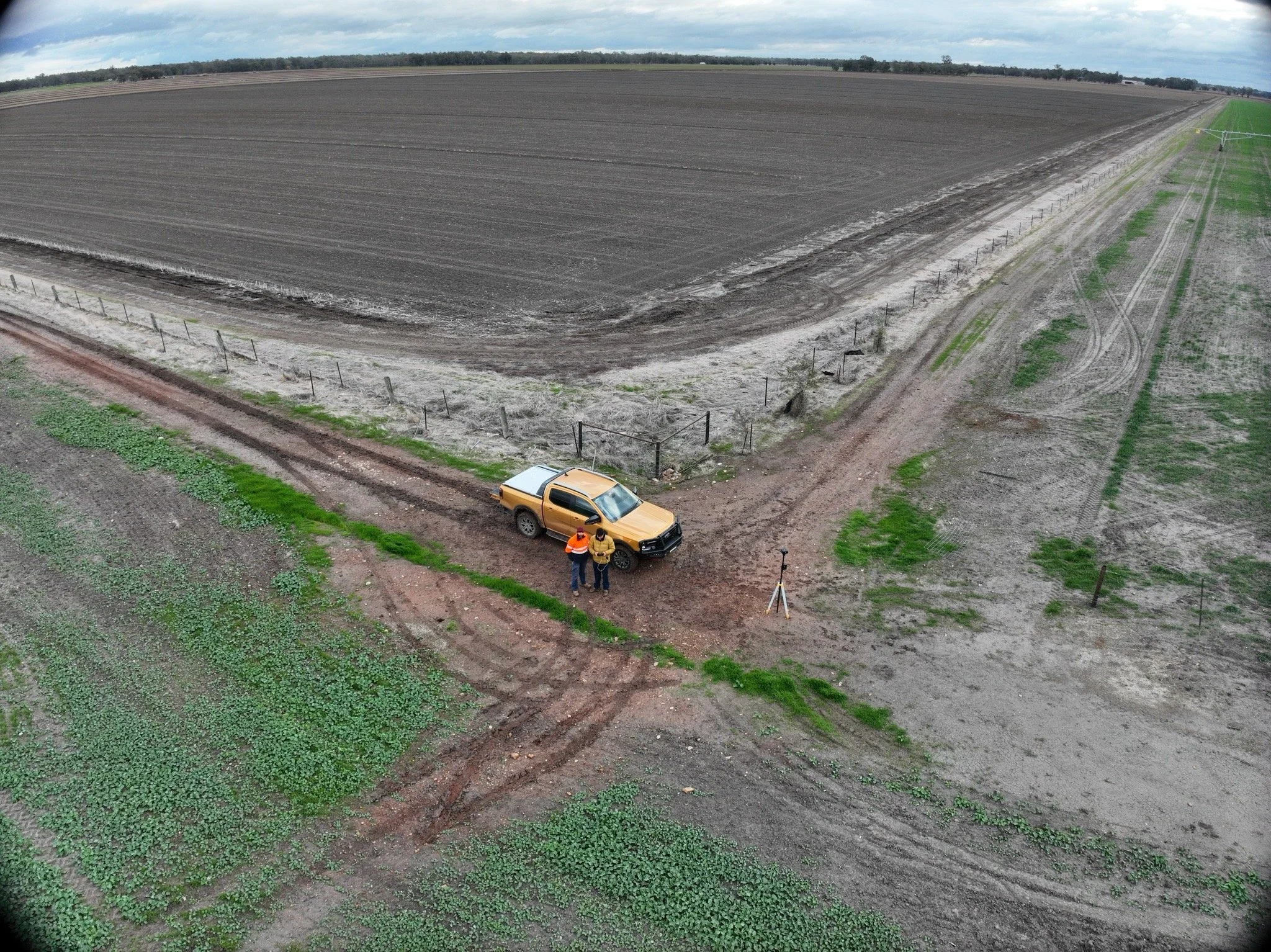 aerial image showing field with truck and workers