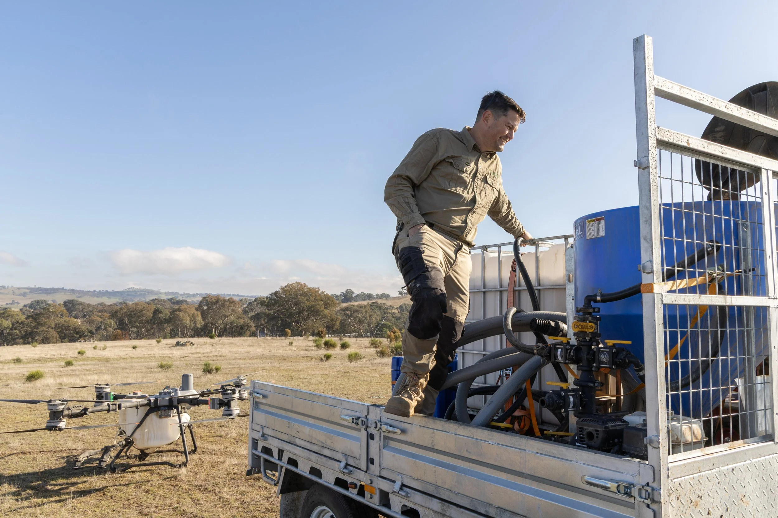 Michael standing in trailor mixing with drone behind him on the ground