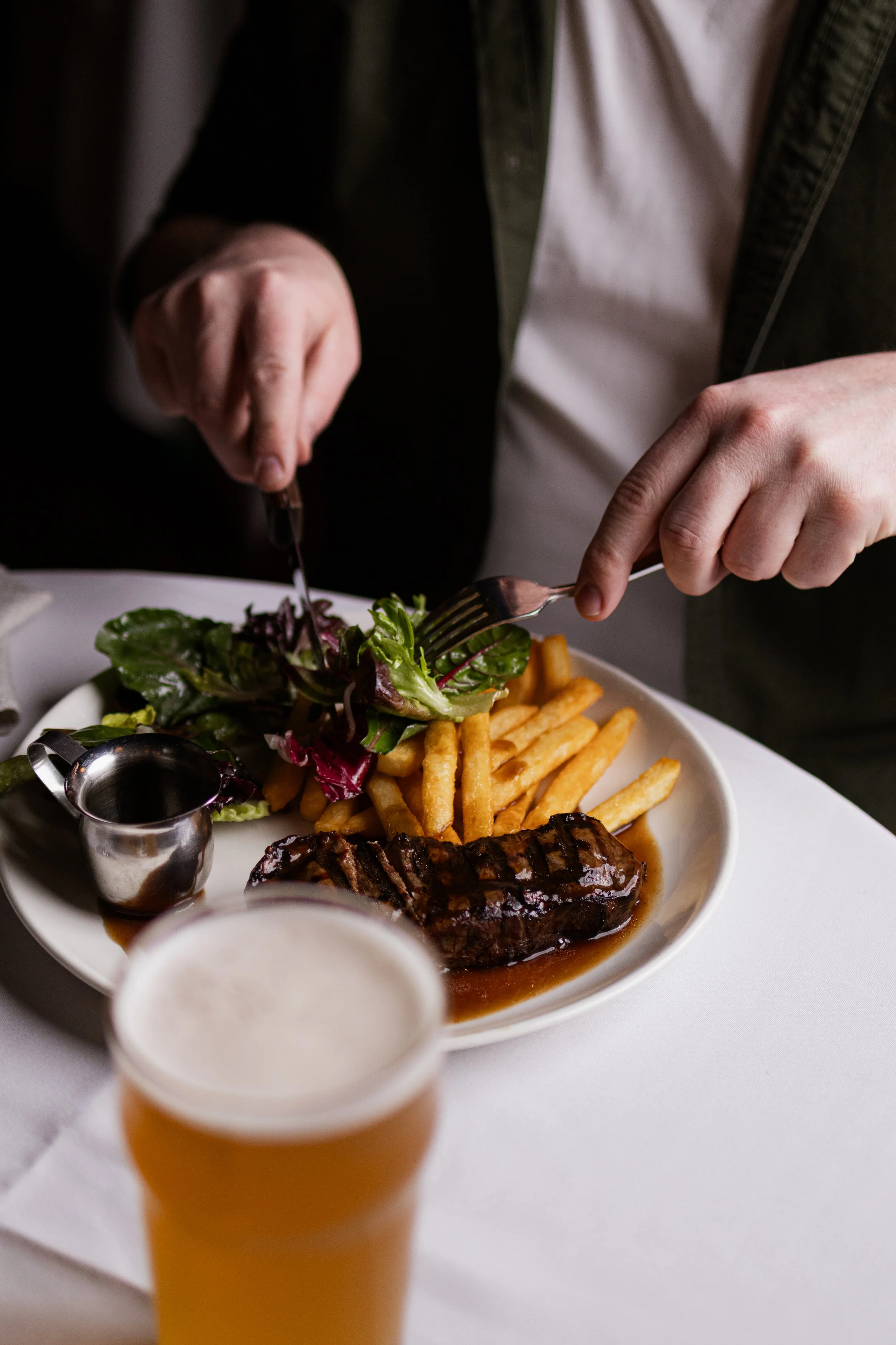 Sign advertising Wednesday steak night featuring porterhouse steak for $25, served with chips, salad, and sauce.