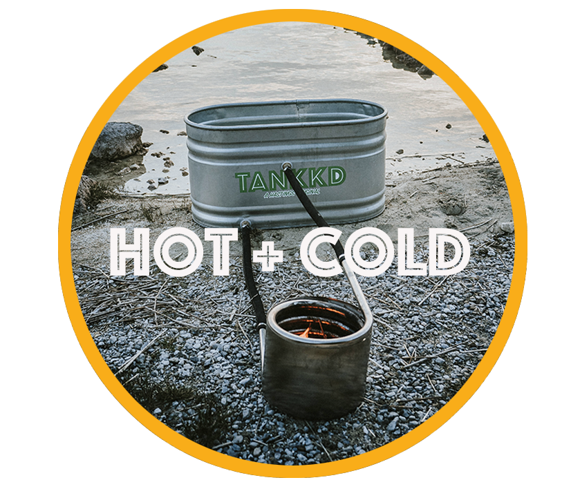 A portable cooking pot with a lid inside a metal water container on a rocky shoreline, with the words 'HOT + COLD' overlayed.