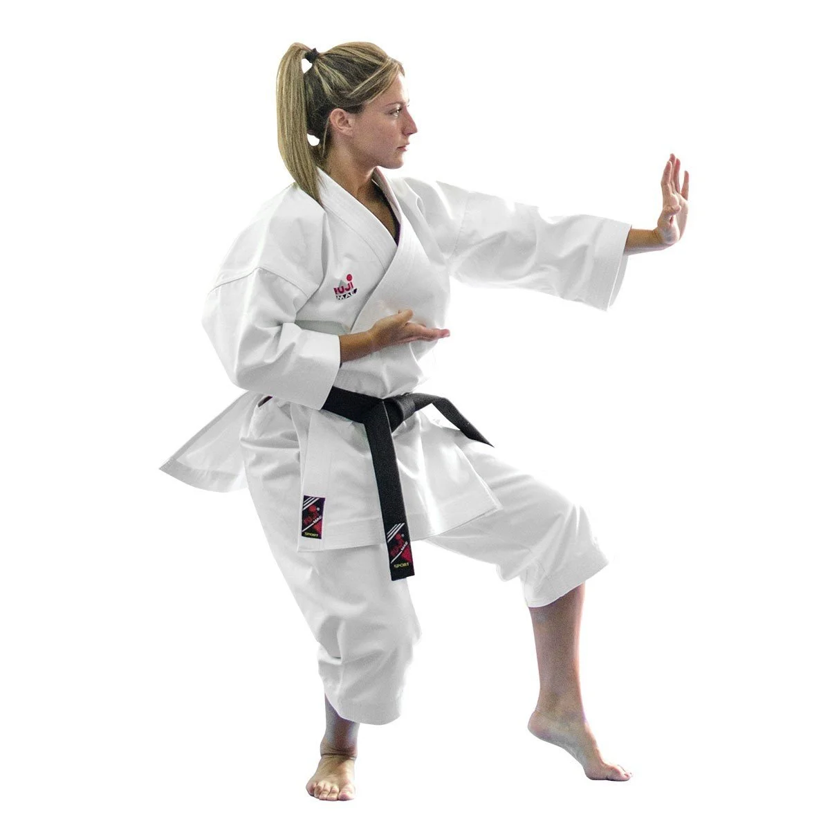 A woman in a white karate gi performing a martial arts stance with one hand extended and the other near her waist, on a white background.