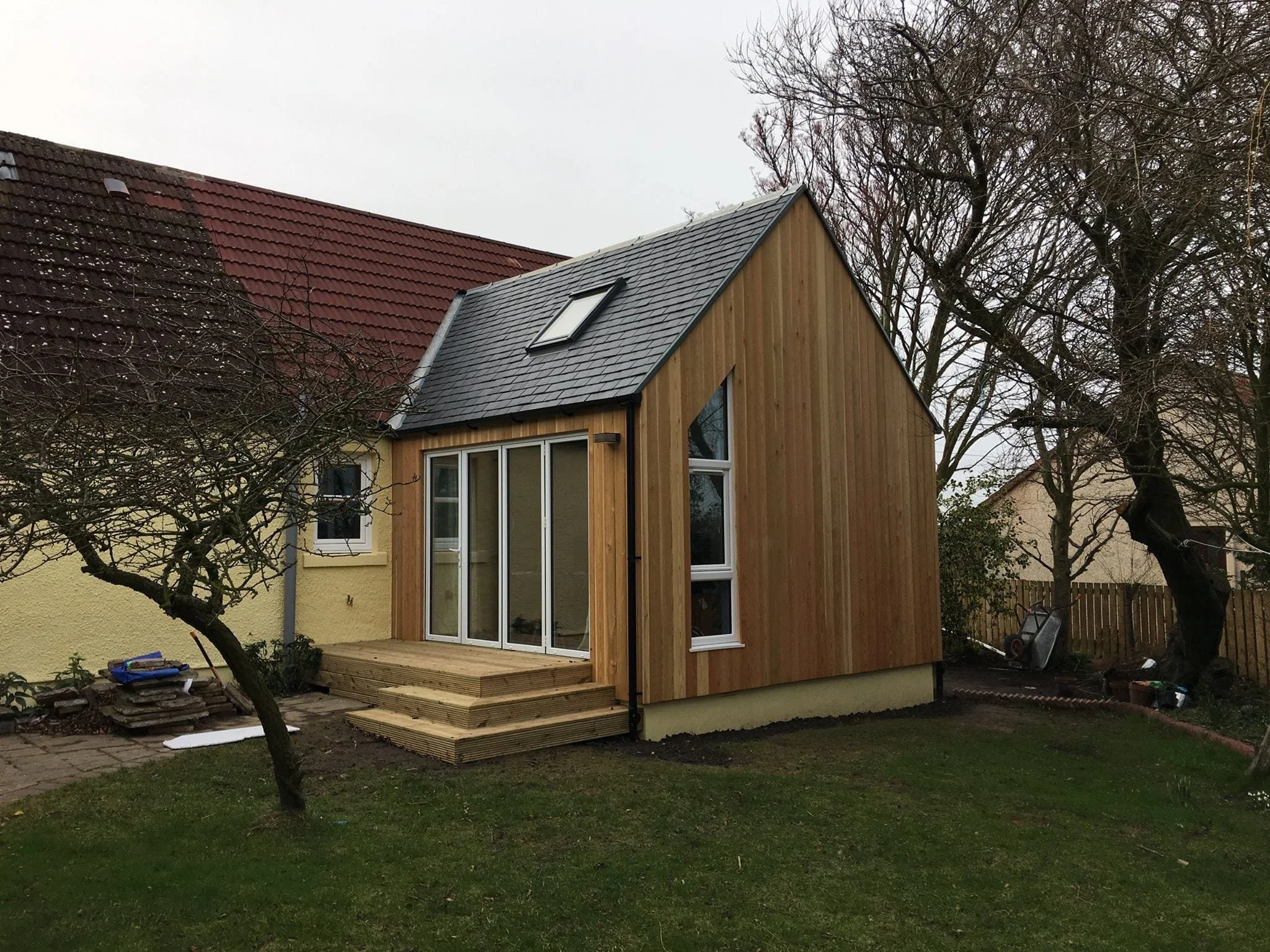 Extension in wood cladding modern attached to bungalow