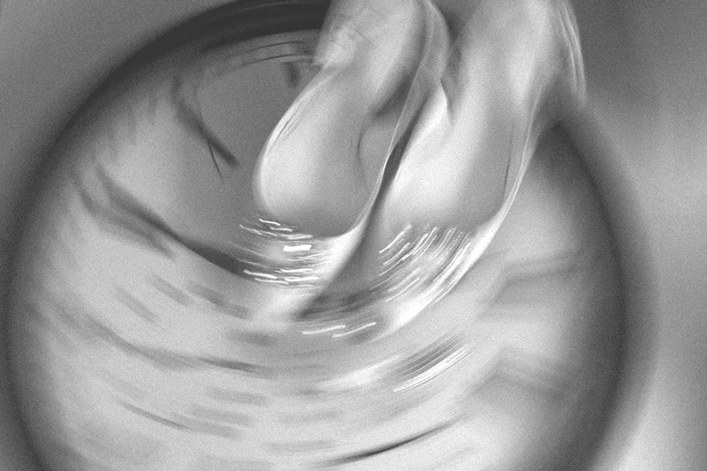 A top-down view of a glass of water with ice cubes, seen through the clear liquid.