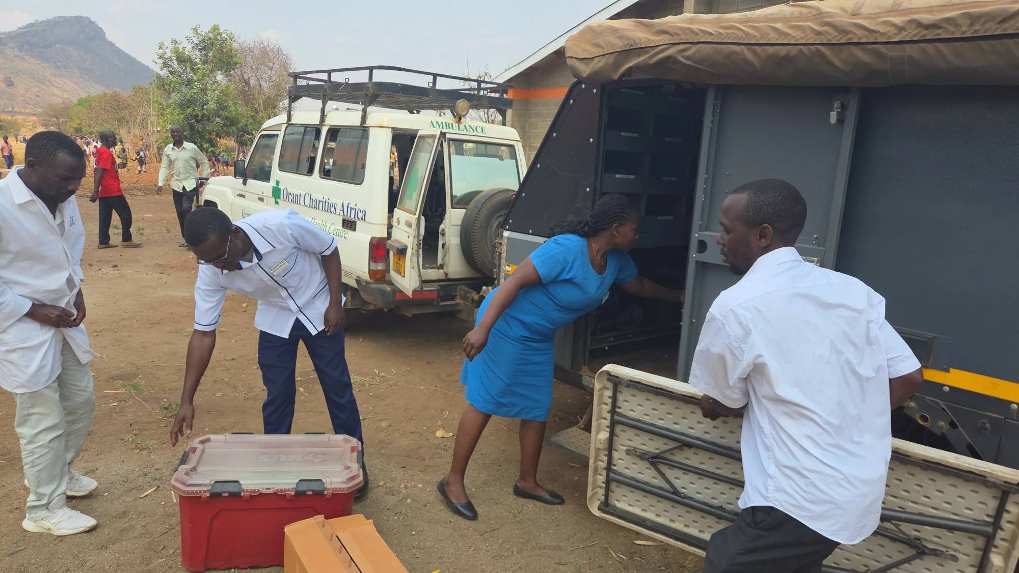 Orant Charities Africa staff unload the mobile pharmacy and set up an outreach clinic in a village in Malawi