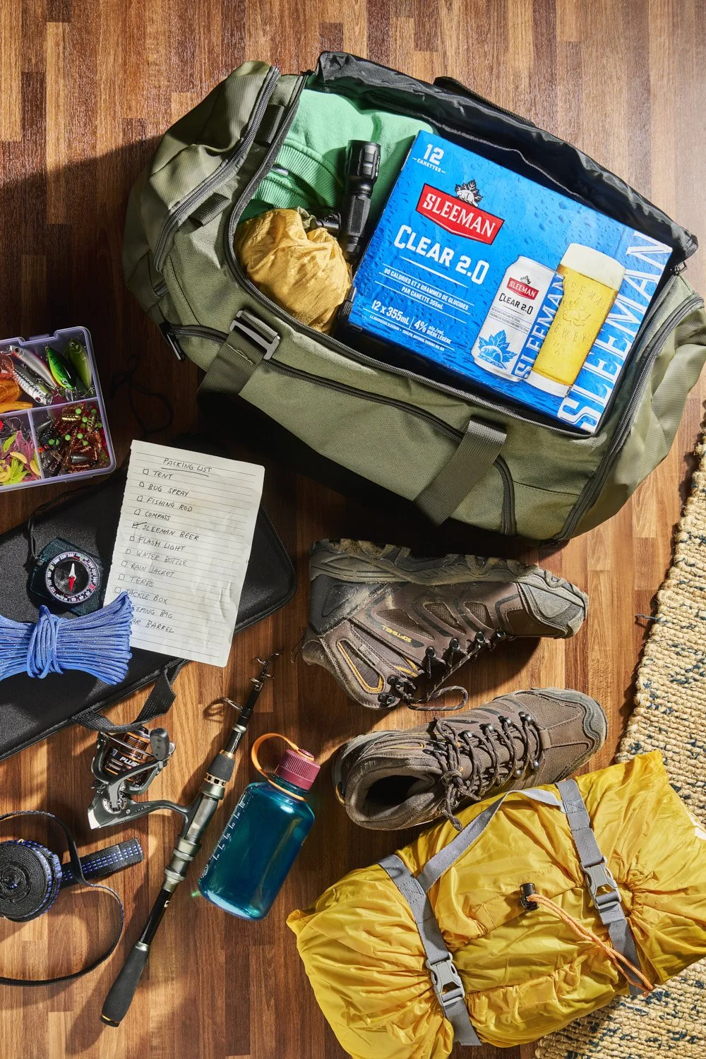 Branded canned beverages packed into a portable cooler bag with ice, lifestyle product shot with casual outdoor feel and soft daylight lighting