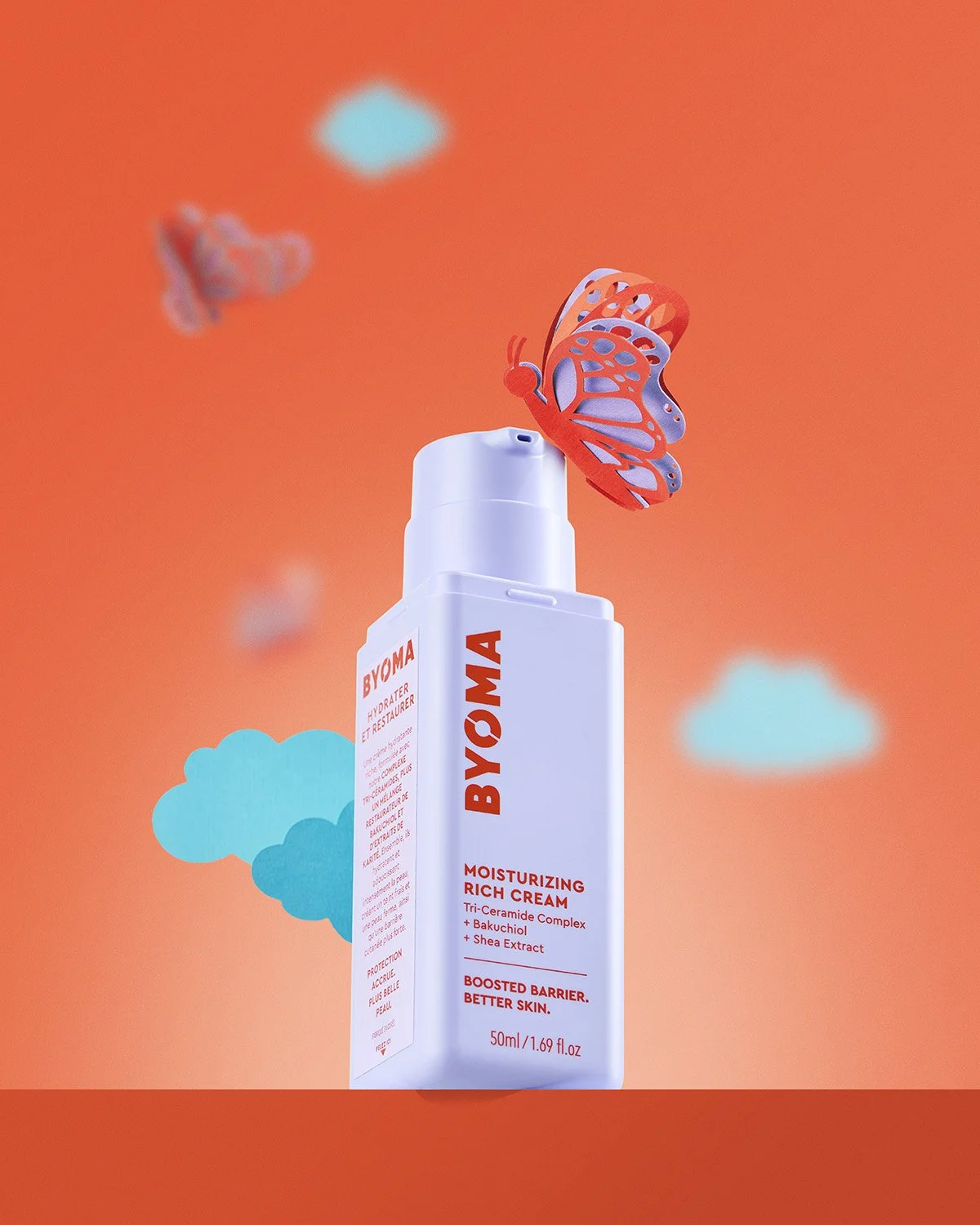  Byoma skincare tube standing upright on an orange background with small blue clouds and a butterfly, bright commercial product shot with bold graphic styling