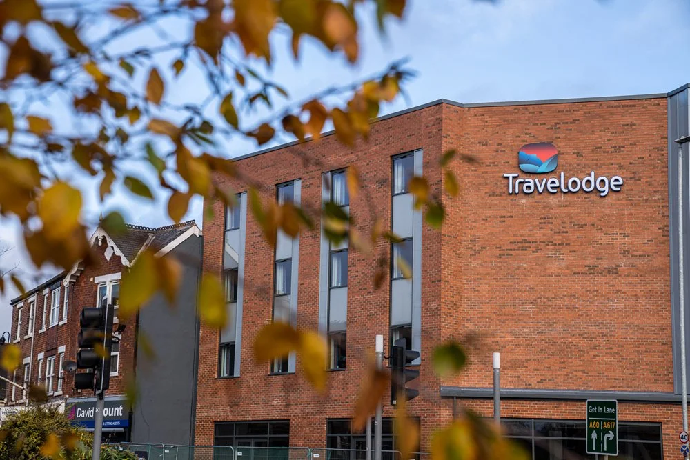 Travelodge hotel building with autumn leaves in foreground
