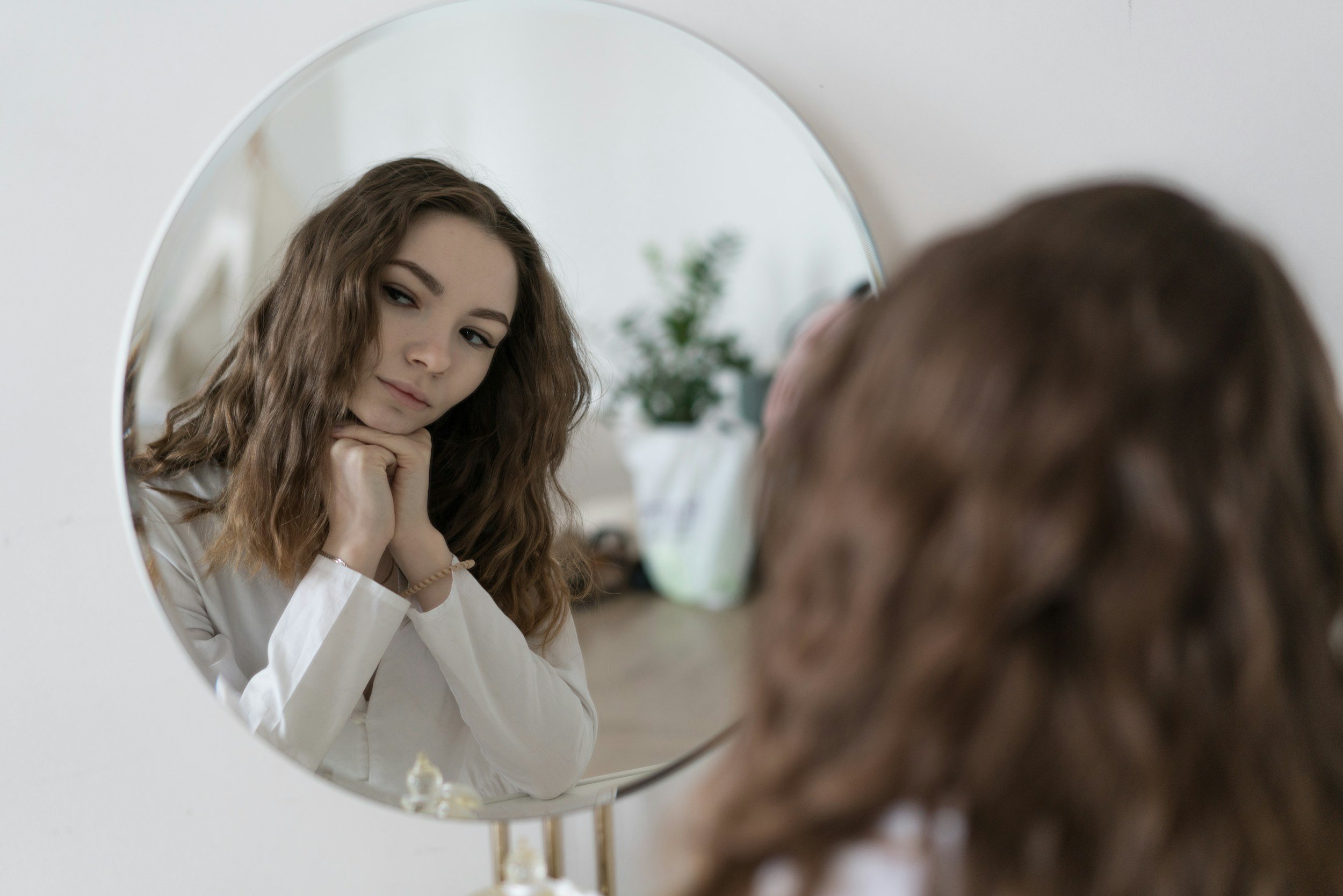 Woman noticing hair loss from stress, trichologist Ruth Collis in Haywards Heath, West Sussex explains what's really happening