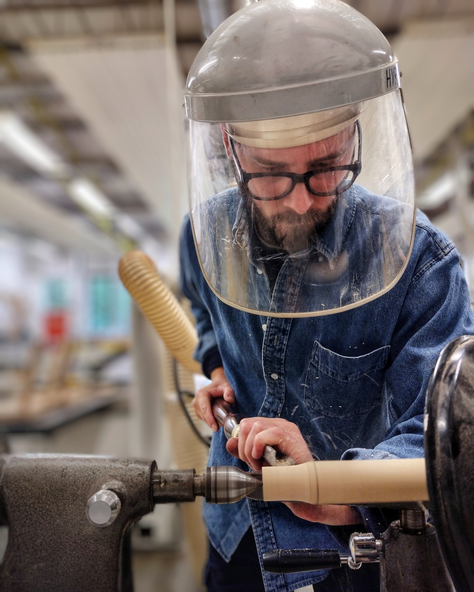 Ellis James Stacey turning wood on a lathe in his Oxford studio, crafting bespoke handmade furniture using traditional woodworking techniques.