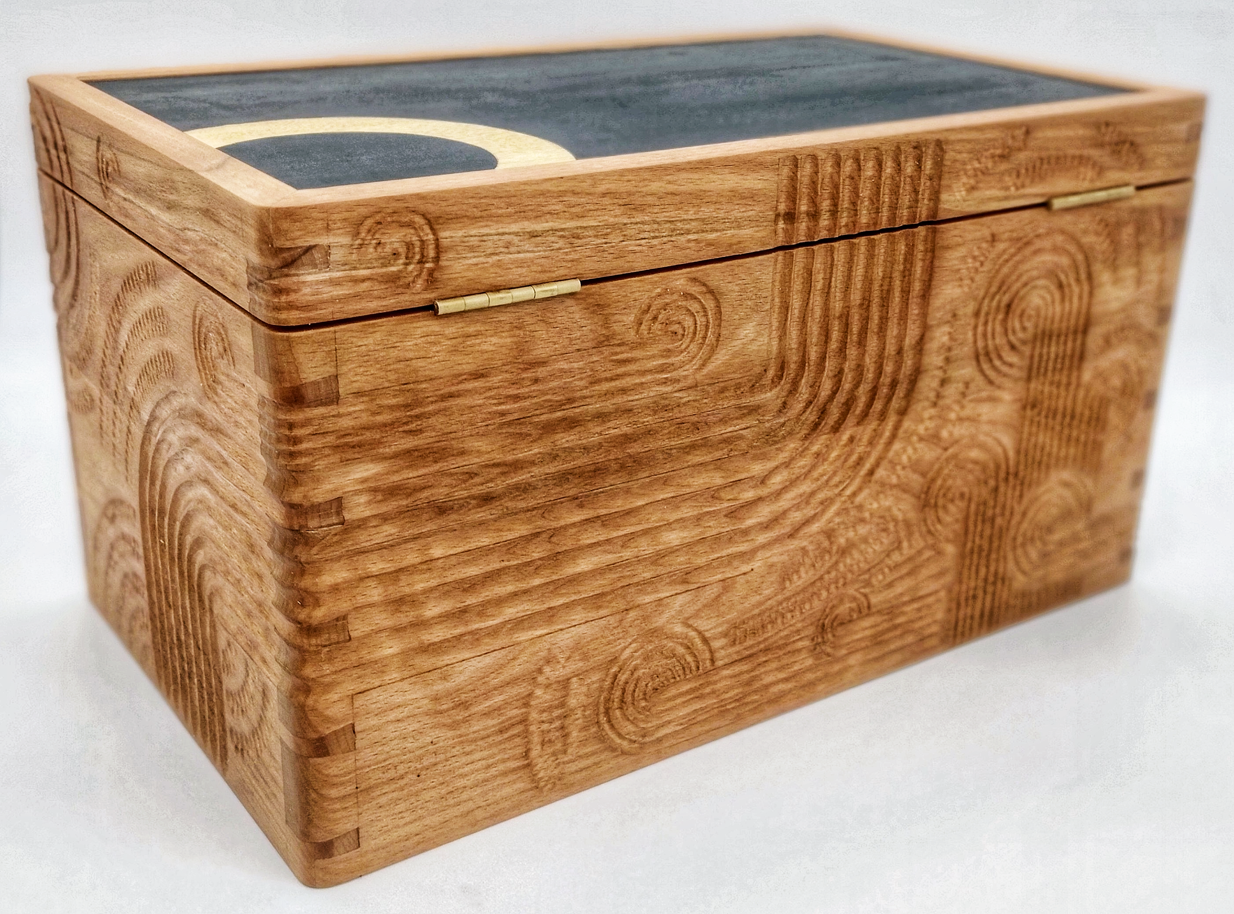 bespoke wooden box Oxford, hand-carved relief box, luxury handcrafted furniture UK, Polynesian-inspired carving, Mesoamerican art influence, custom art box, British studio furniture maker, Ellis James Stacey bespoke furniture.
